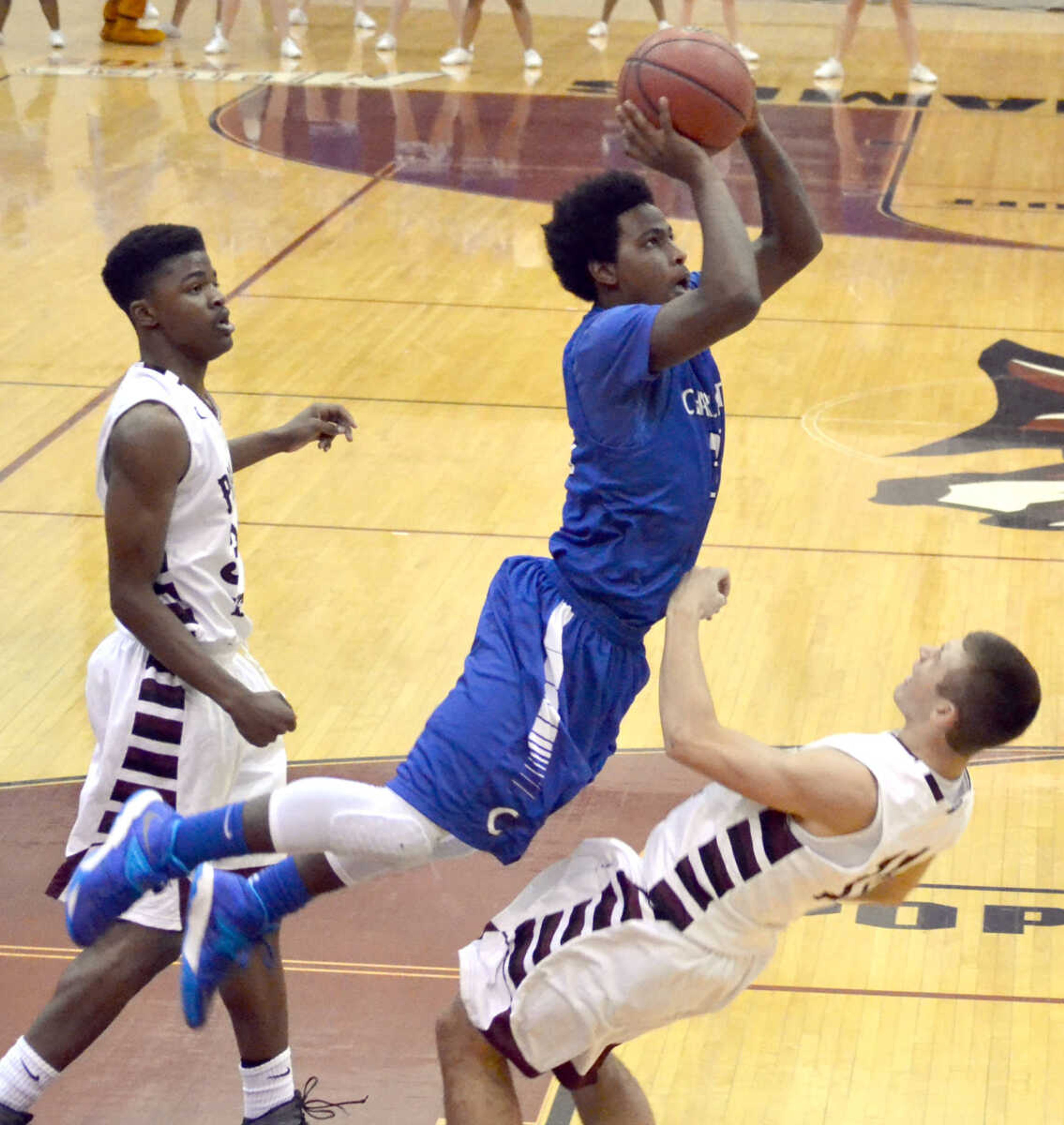 Charleston's Mike Kellum attempts a shot over Poplar Bluff's Lucas Tibbs Friday at Poplar Bluff High School. (Brent Shipman photo)