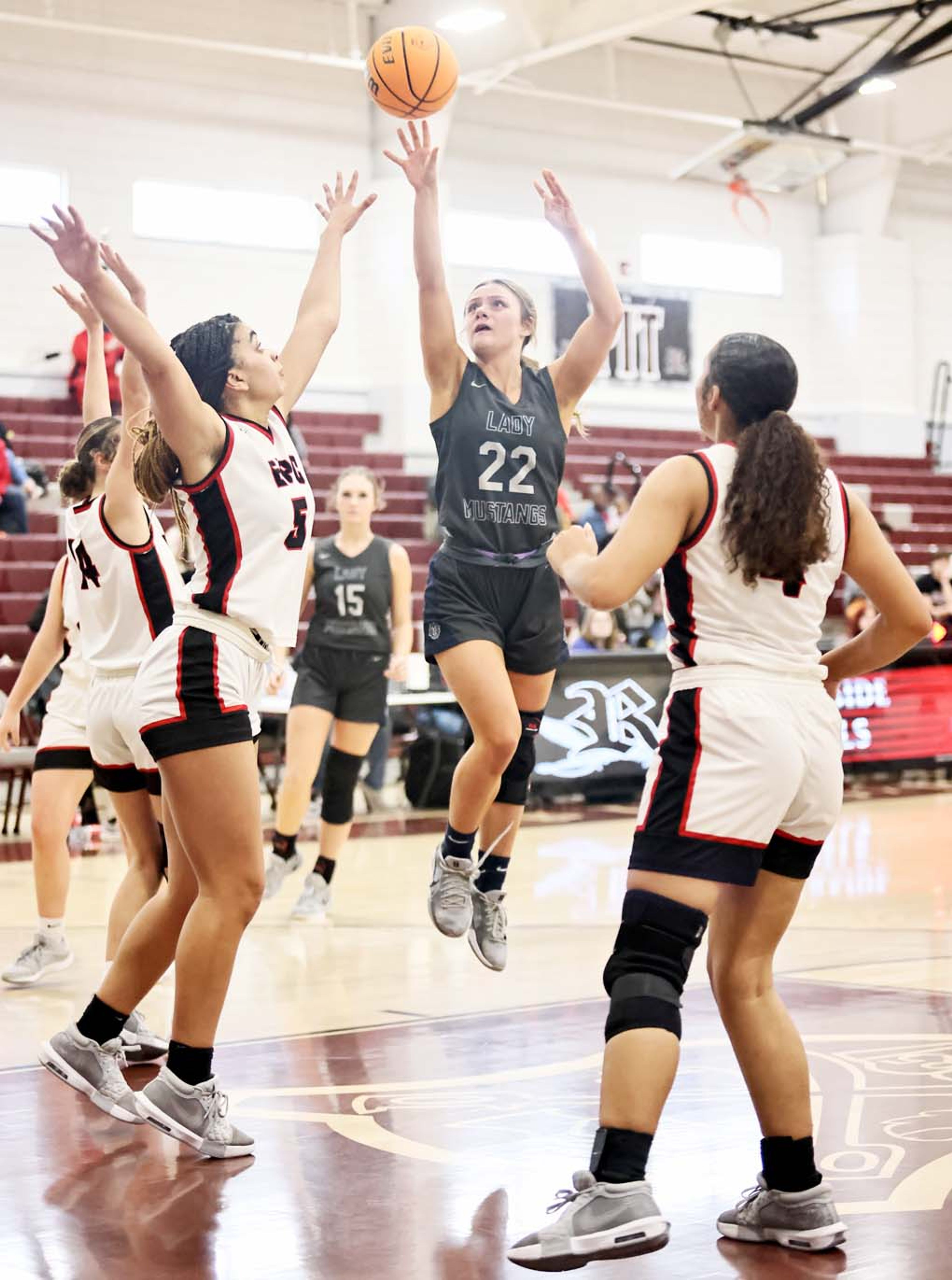 BIC’s Emma Kate McCord shoots a jumper in the lane as Kyla Harston defends and JaLyn Constant looks on during 2A North Regional consolation game action this past Saturday. (Photo by Cosmo Cossey)