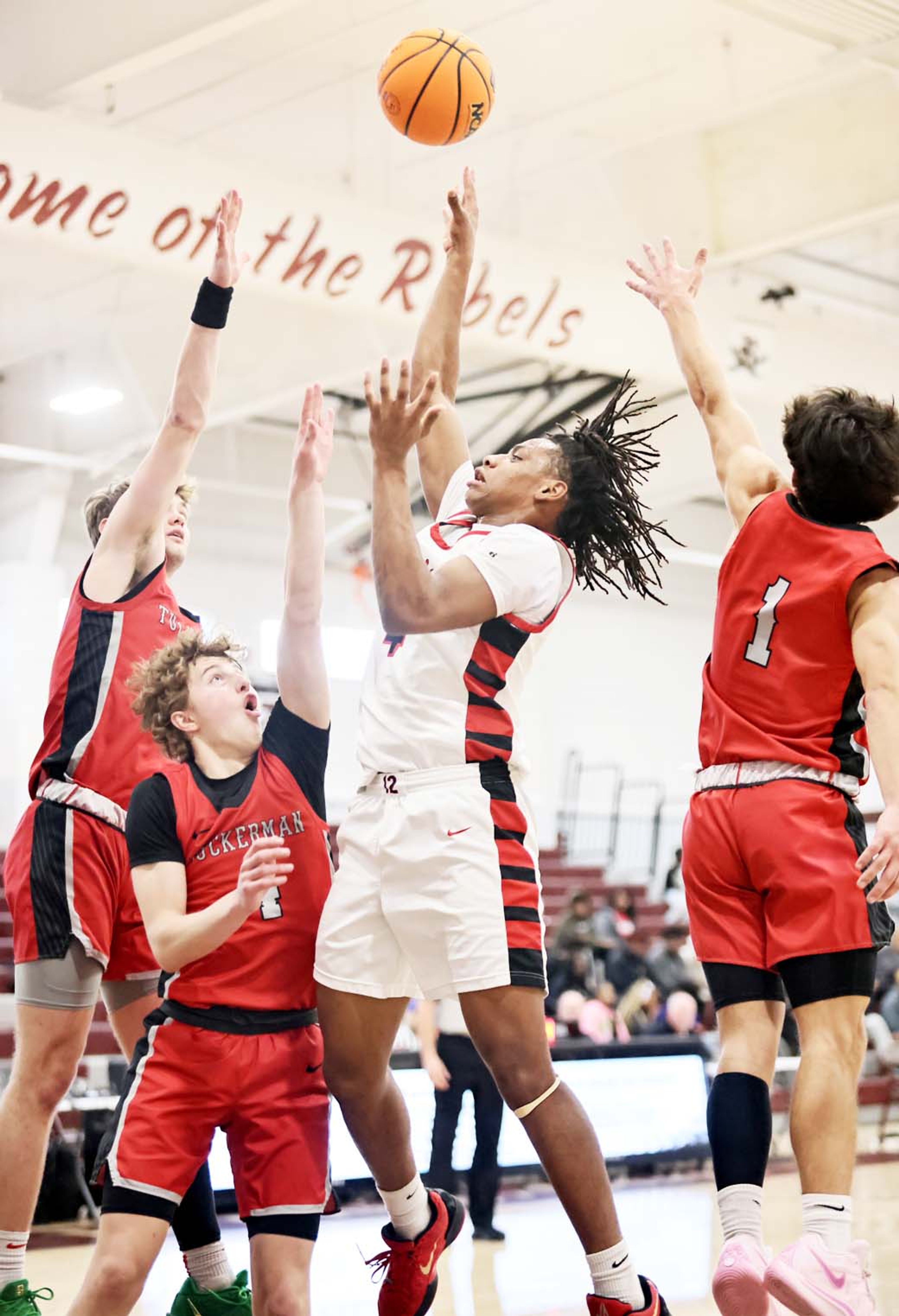 Warrior Jacob Gaines takes a shot in the middle of a trio of Tuckerman defenders during game action this past Saturday in Lake City. (Photo by Cosmo Cossey)