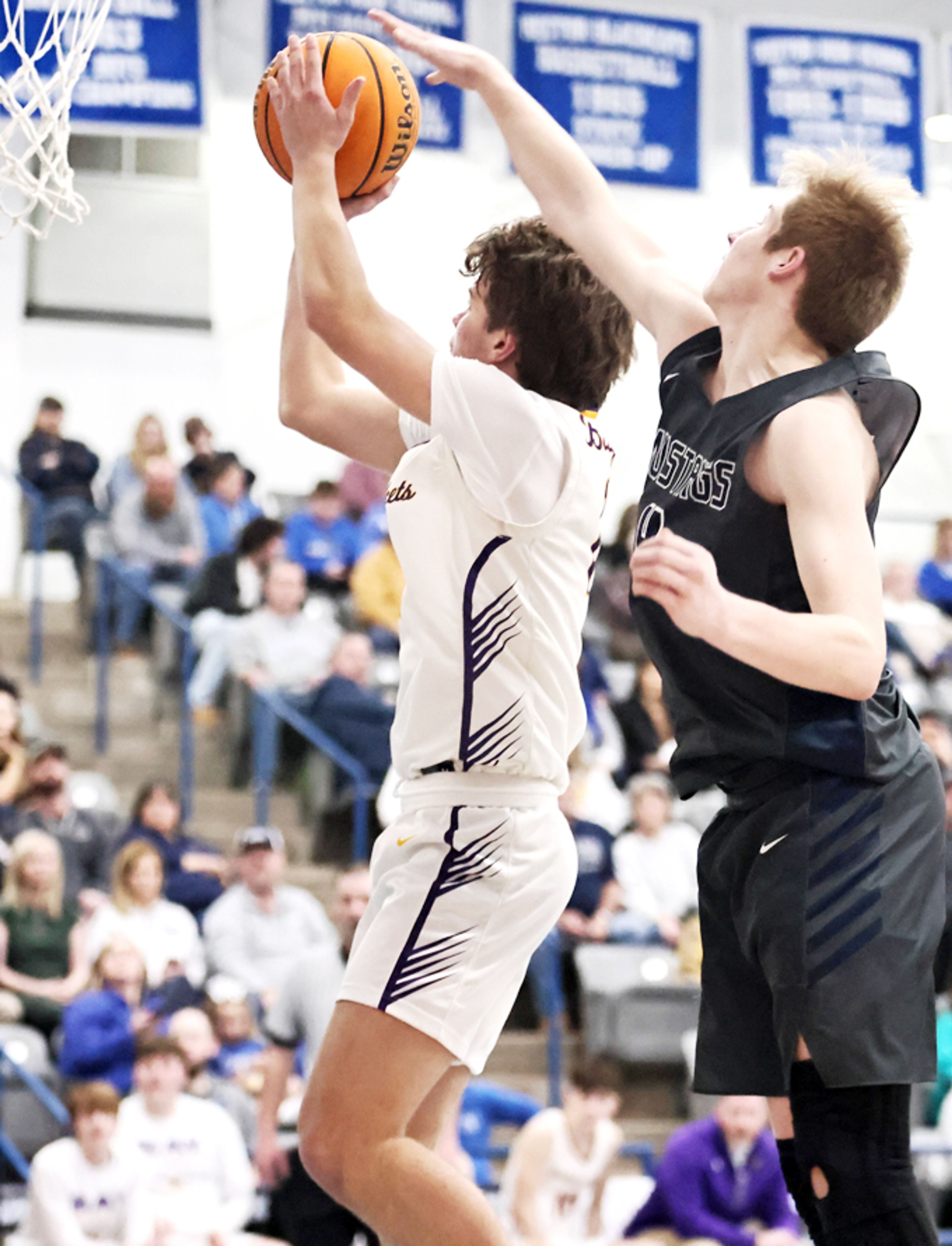 Mustang Braxton Matheny tries to get a hand on the ball as Noah Watson takes a shot for Bay during quarter-final action in Rector. (Photo by Cosmo Cossey)
