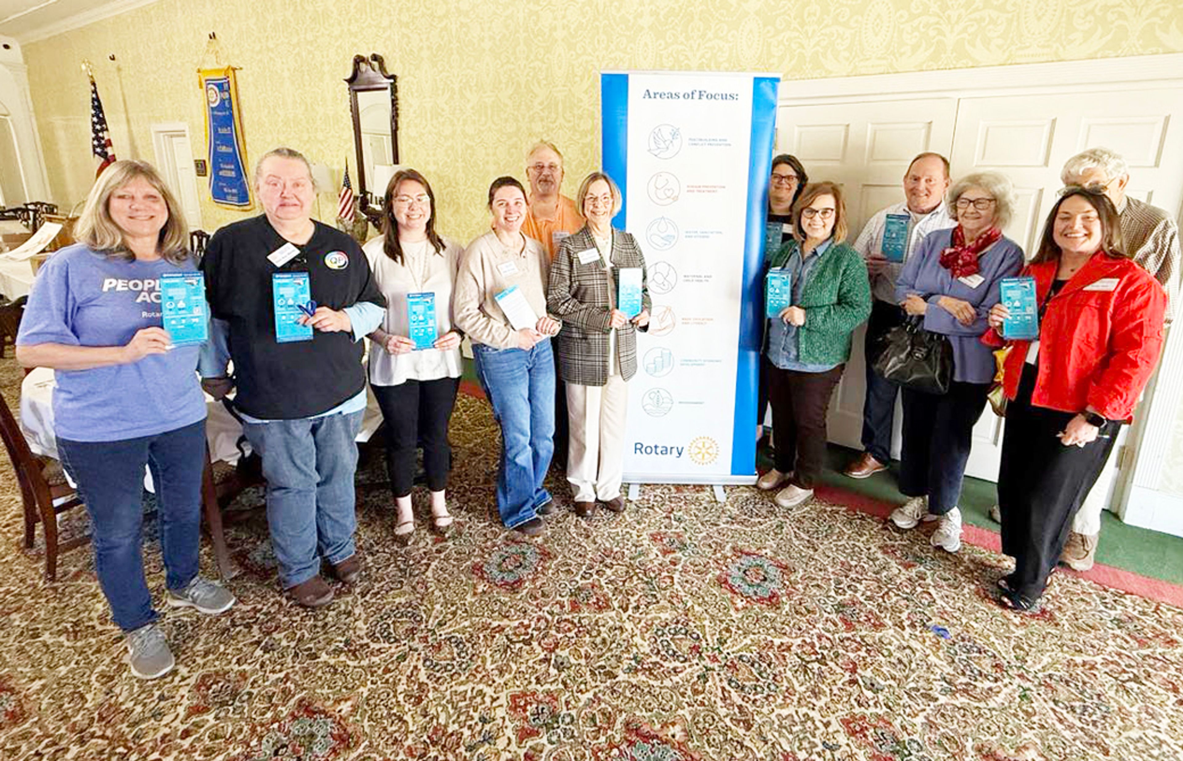 The Blytheville Rotary Club holds out pamphlets supporting organ and tissue donations along side the program Mary Beck, of Mid-South Transplant.