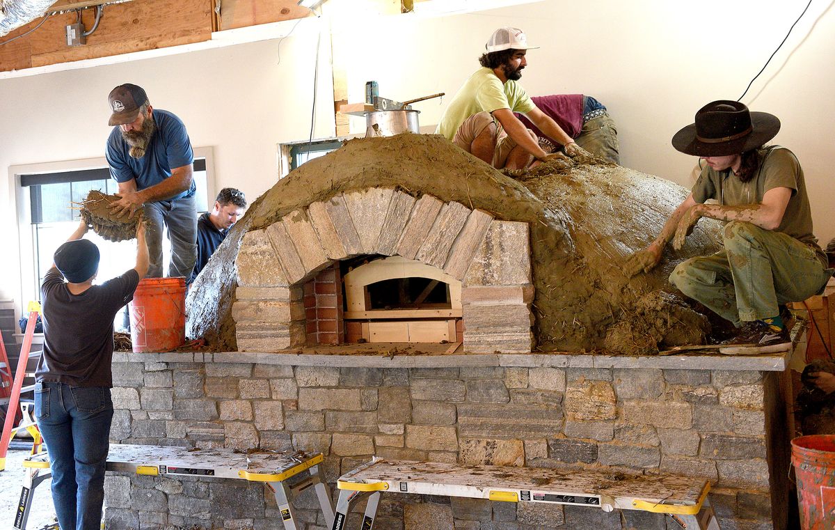 Flatbread Co. enlists the help of dozens to build its clay o...