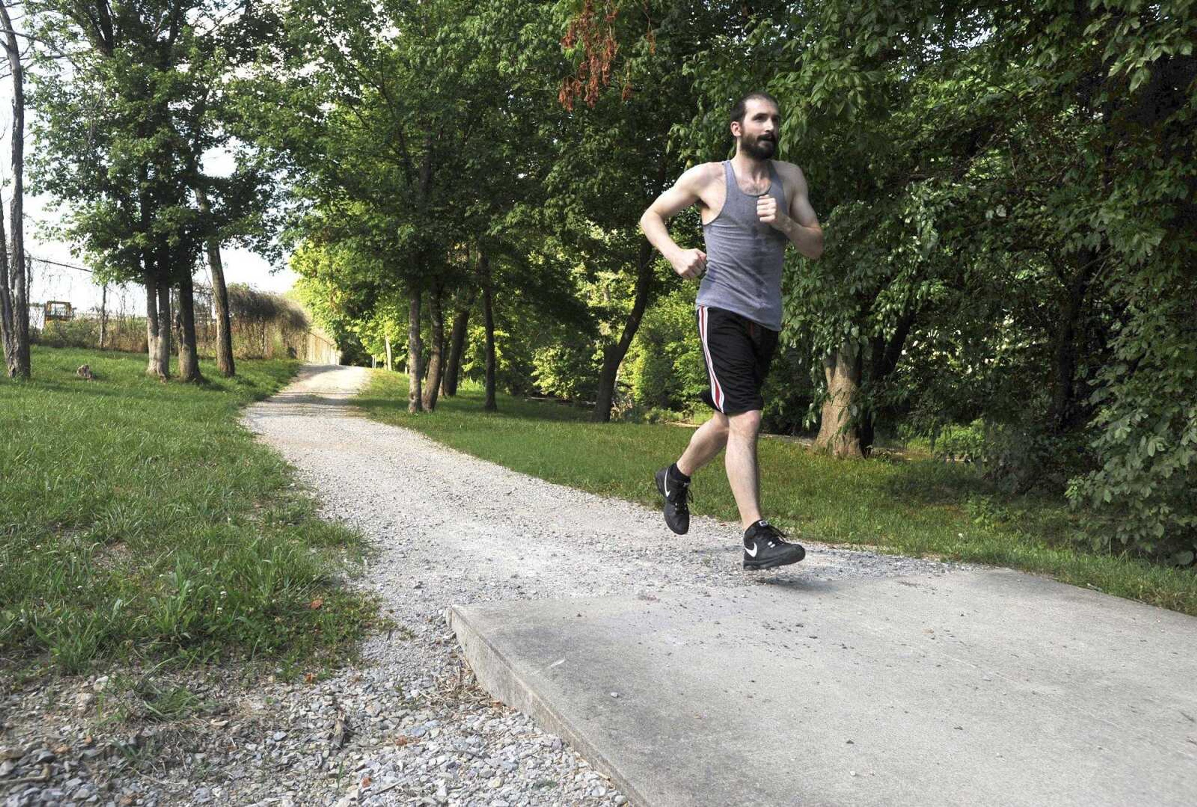 Tim Perry completes a jog Monday along a gravel stretch of the Hubble Creek Recreational Trail in Jackson. The trail runs from Jackson City Park to near Brookside Park.