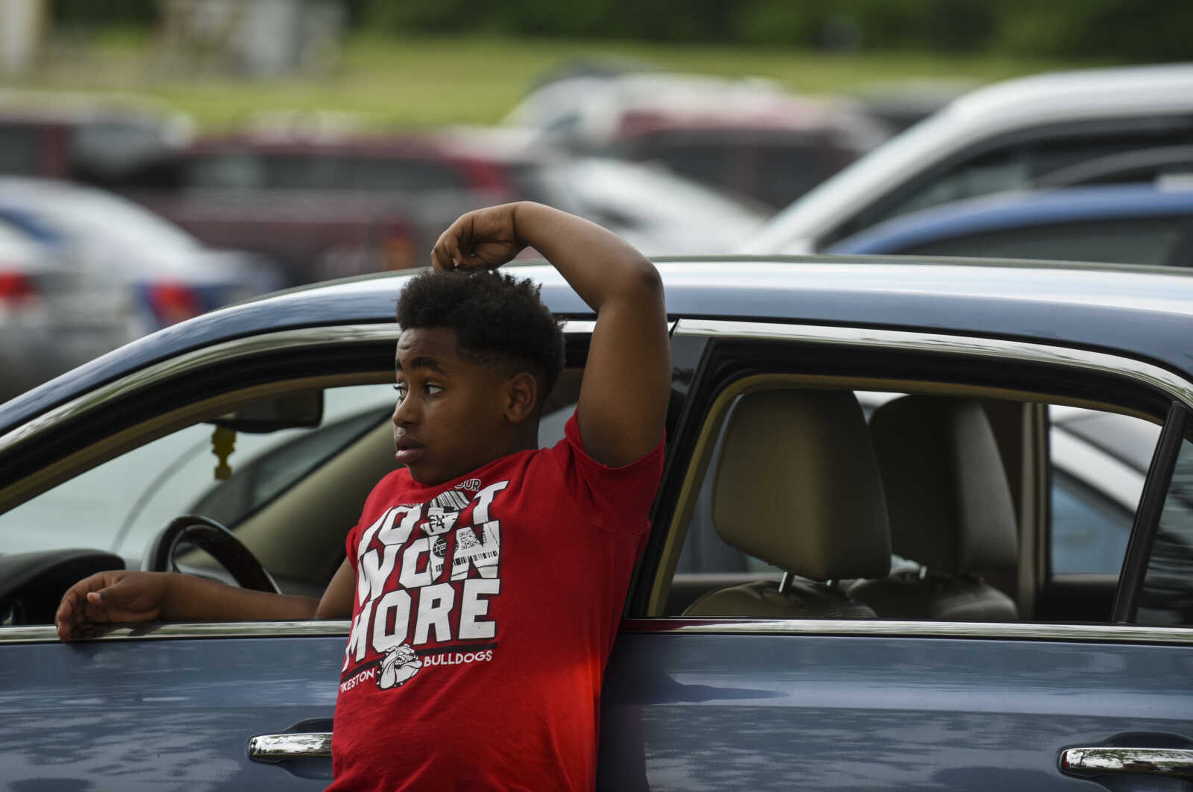 Maliek Patterson leans up against a family's car while waiting outside of the Jefferson City Correctional Center Monday, May 14, 2018 in Jefferson City.