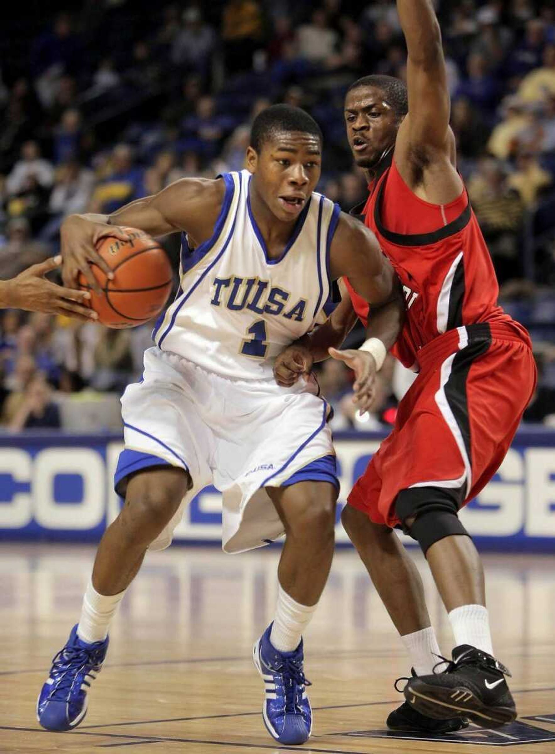 Tulsa's Ben Uzoh drove around Southeast Missouri State's Kendal Deason during their game Saturday in Tulsa, Okla. (MICHAEL WYKE ~ Tulsa World)