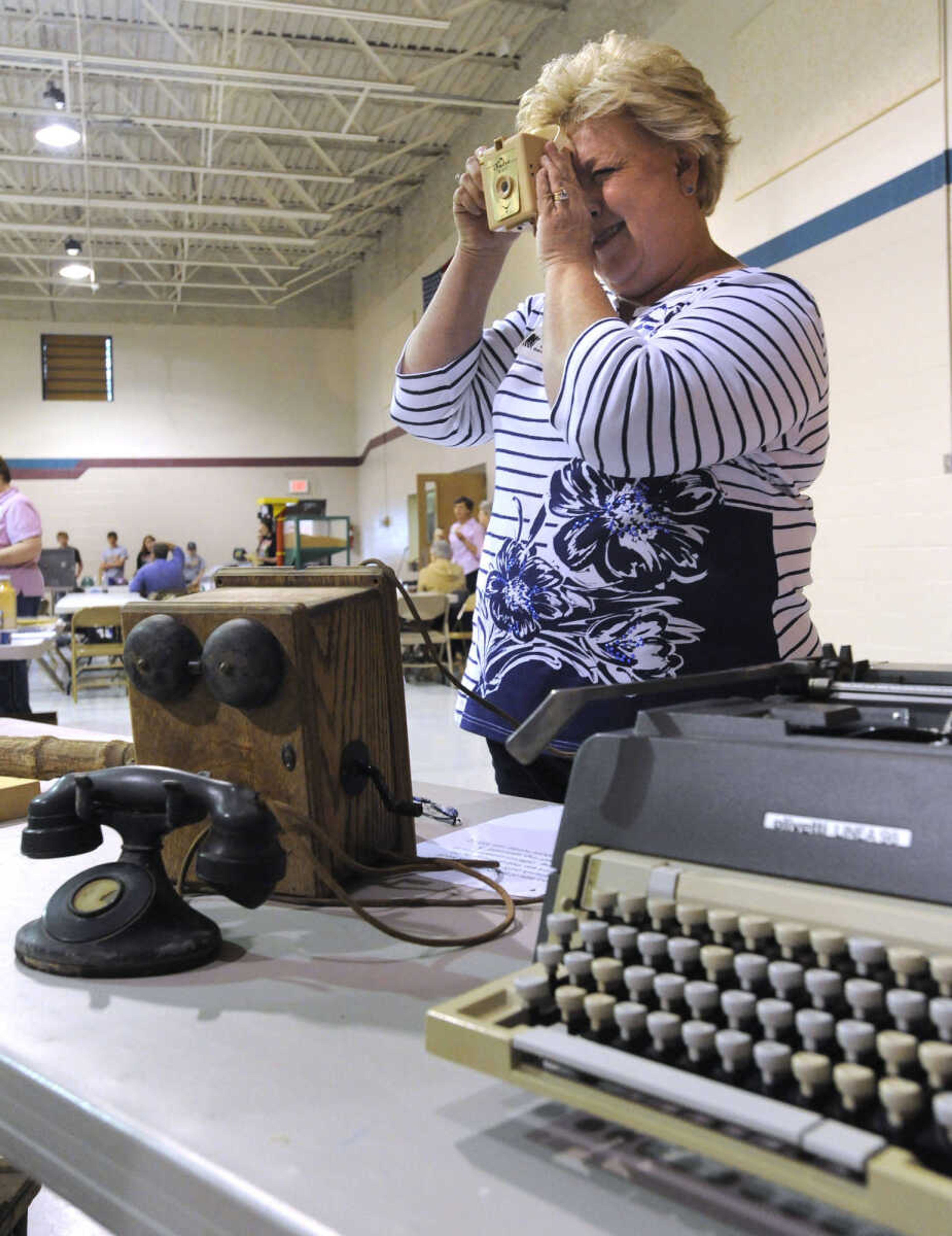 Bernadette Stricker, a member of the Scott County Women in Agriculture, shows a few items that people used "back when" at the Farm Day event.