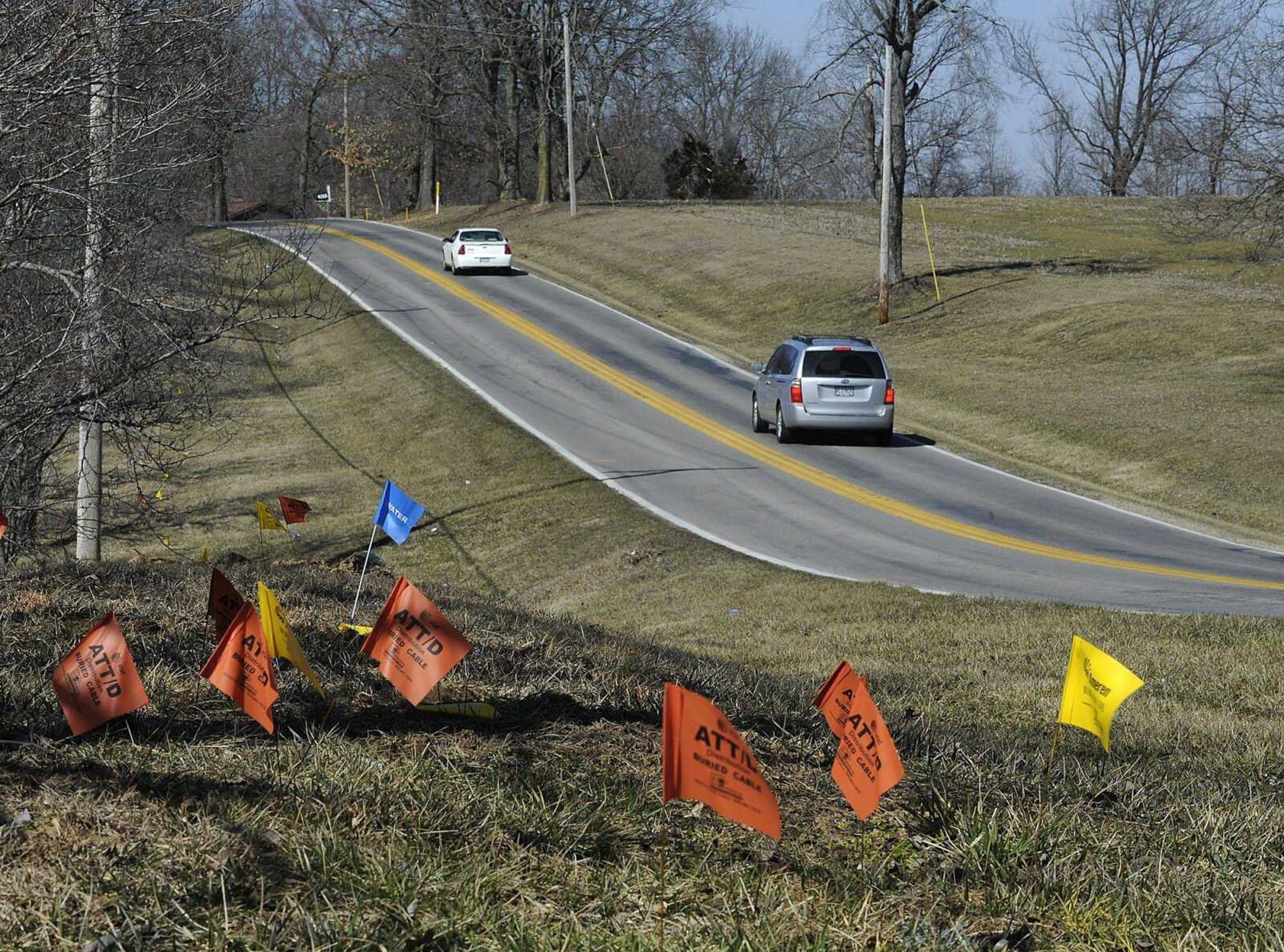 Utility flag markers along several stretches of Route W indicate the forthcoming road widening project between LaSalle and Lexington avenues. (Fred Lynch)