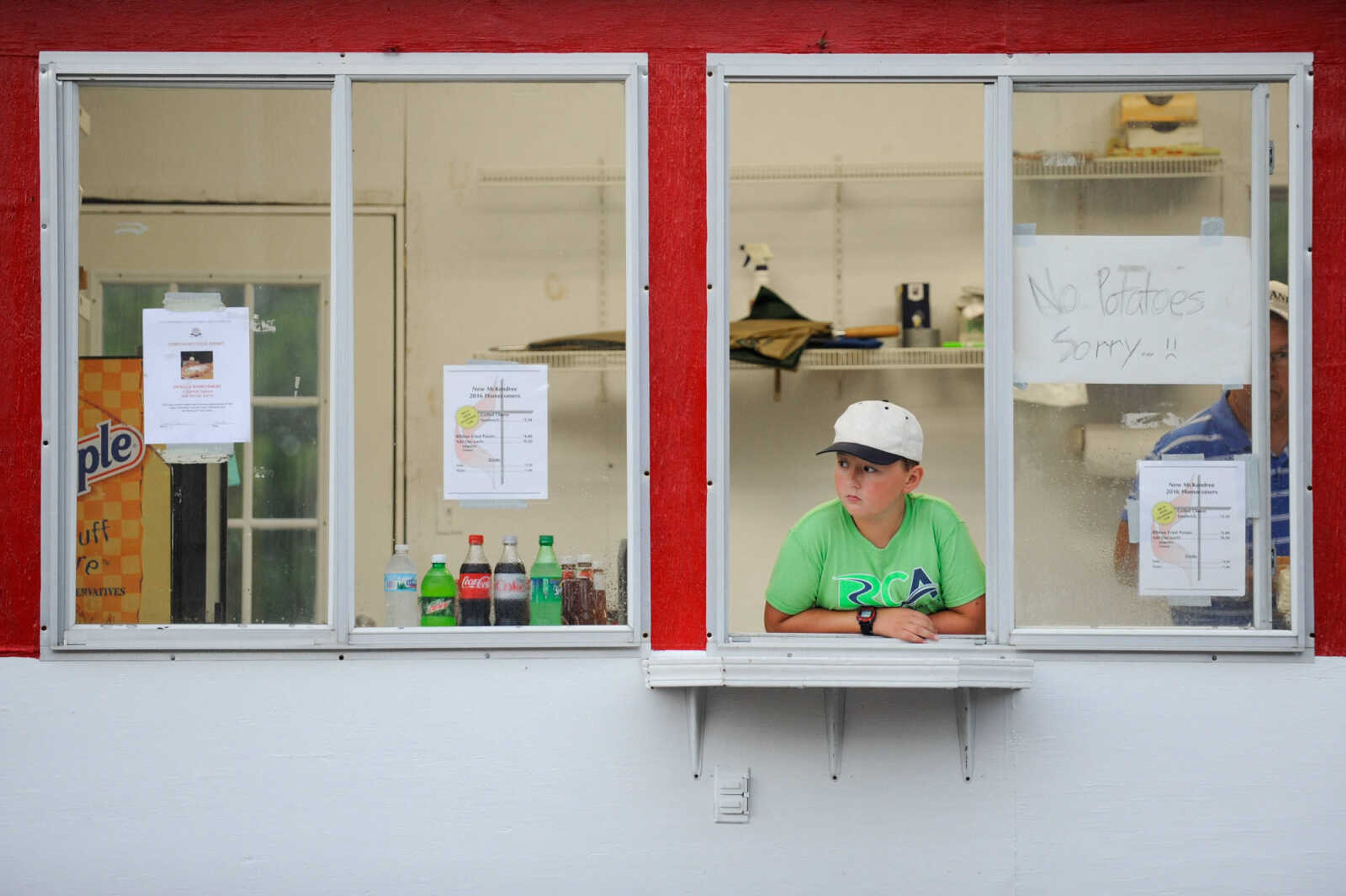 GLENN LANDBERG ~ glandberg@semissourian.com

Jack Dameron looks out from the New McKendree United Methodist Church grilled cheese stand during a rainy opening day of the 108th Homecomers in Jackson, Tuesday, July 26, 2016. Homecomers runs through Saturday in uptown Jackson.