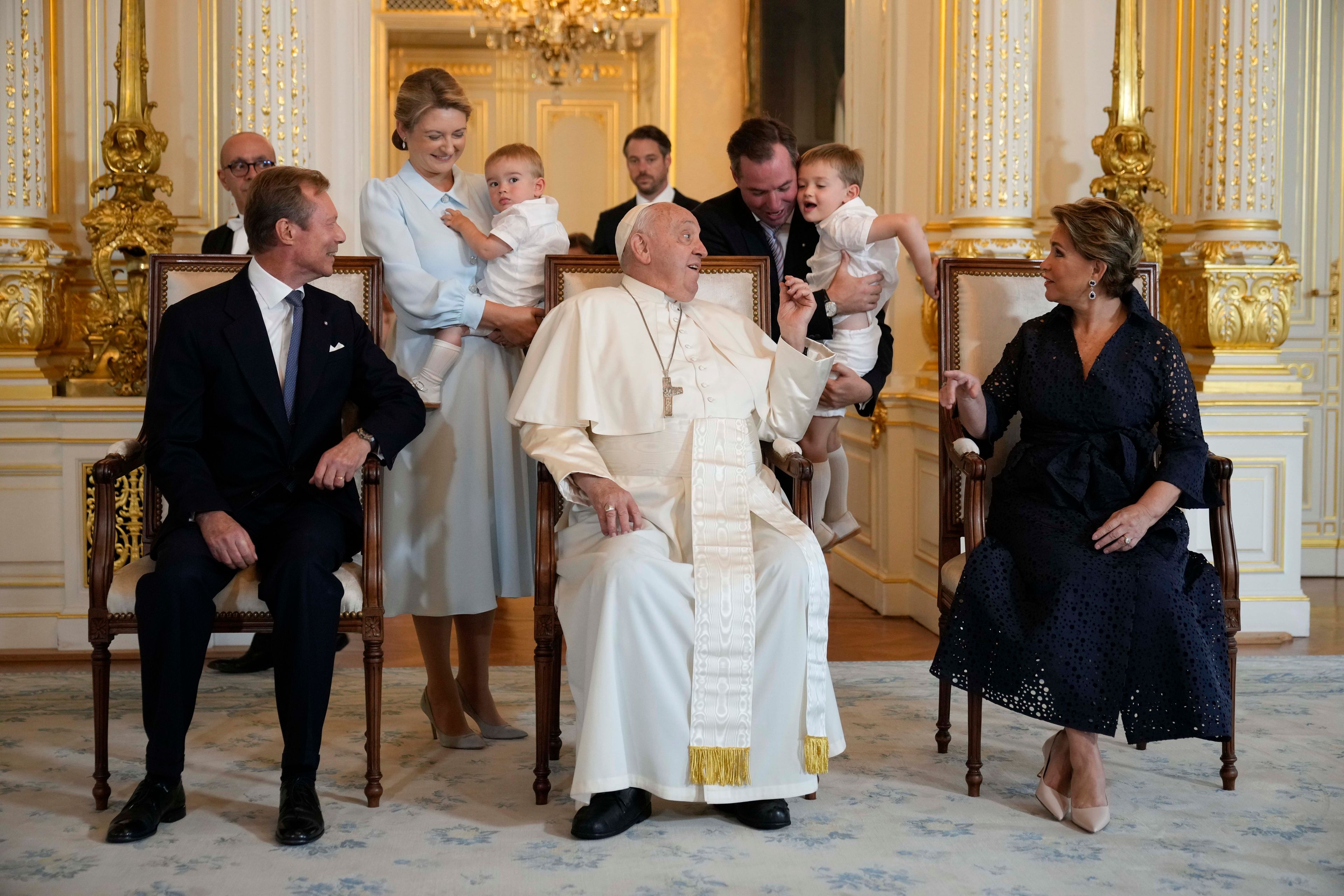 Pope Francis poses for a picture with Luxembourg's Grand Duke Henri, left, Grand Duchess Maria Teresa, right, Prince Guillaume Jean Joseph Marie, background right, his wife Countess Stephanie de Lannoy, background left, with their children during his visit at the Grand Ducal Palace, in Luxembourg, Thursday, Sept. 26, 2024. (AP Photo/Andrew Medichini)