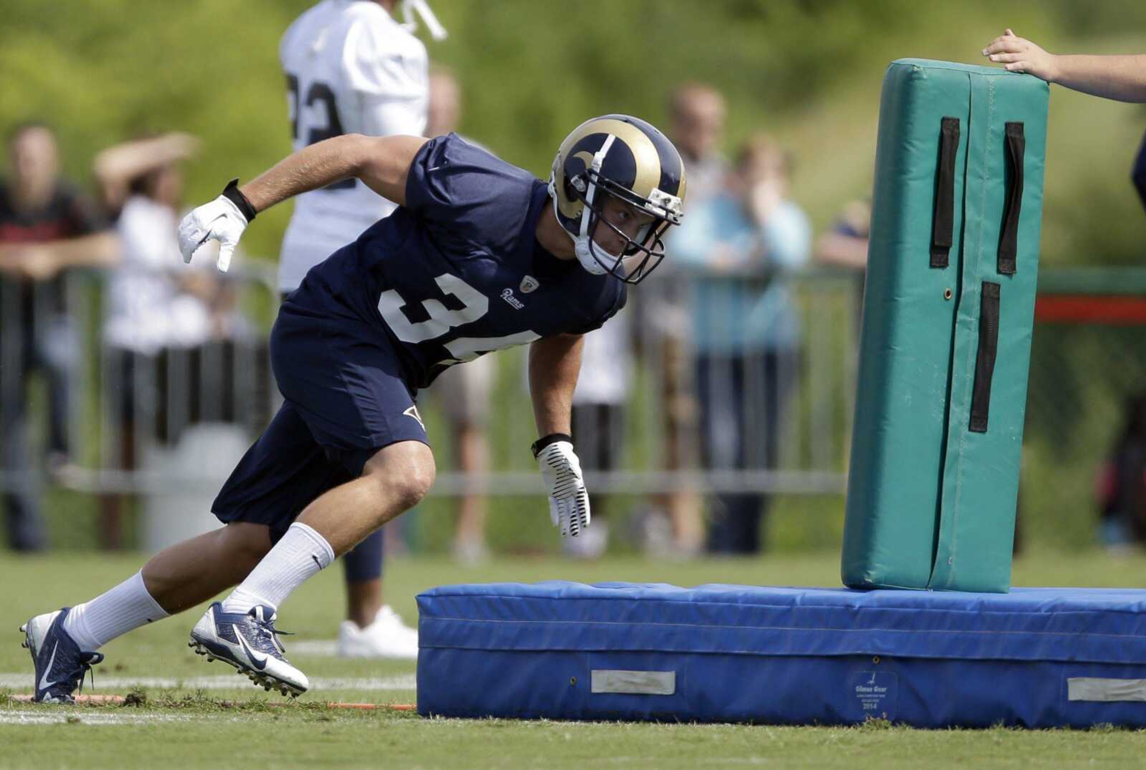 St. Louis Rams running back Chase Reynolds dives into a pad during training camp at the team's practice facility July 25 in St. Louis. (Jeff Roberson ~ Associated Press)