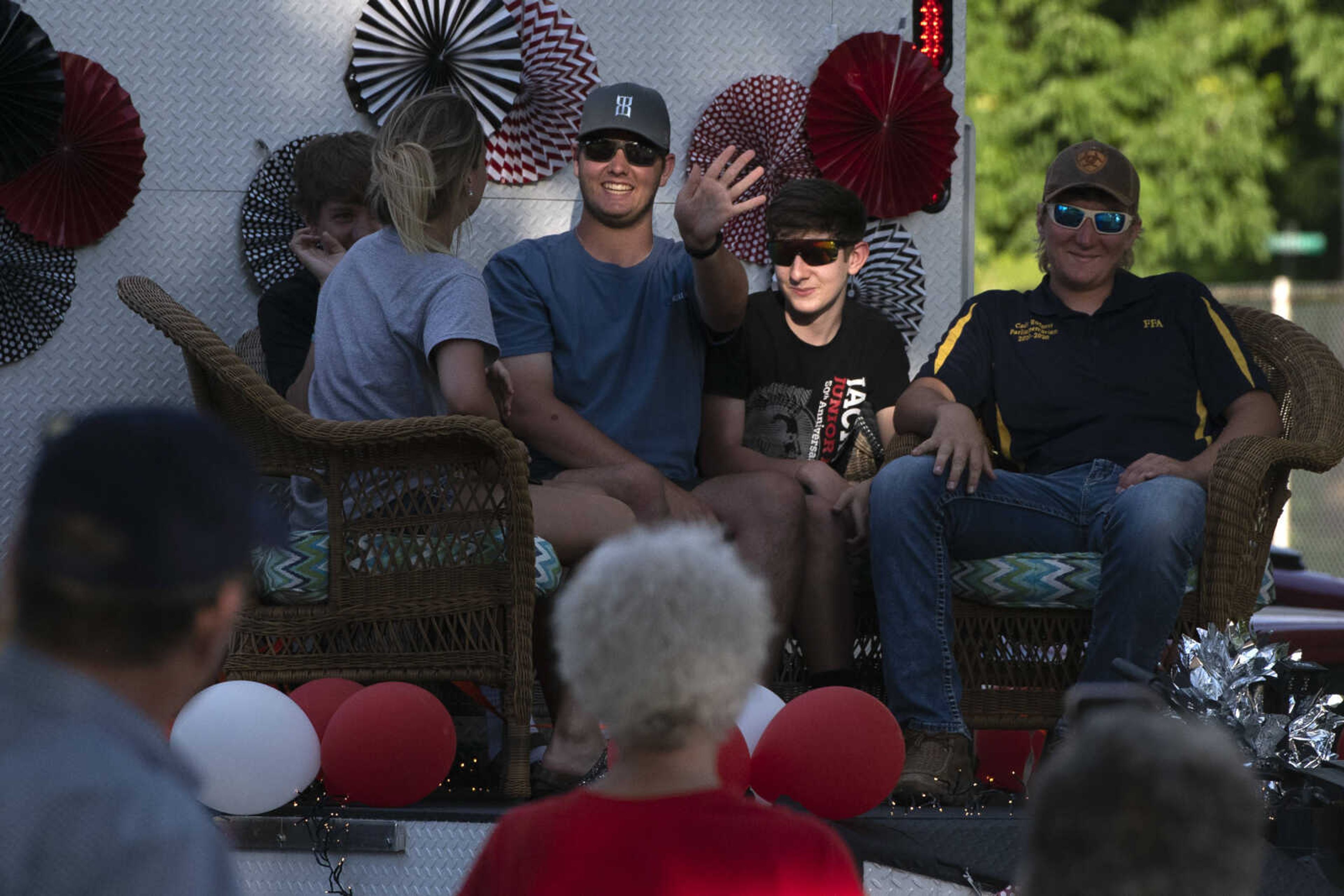 Parade participants wave while taking part in a procession for Jackson High School seniors Friday, May 29, 2020, at Jackson City Park.