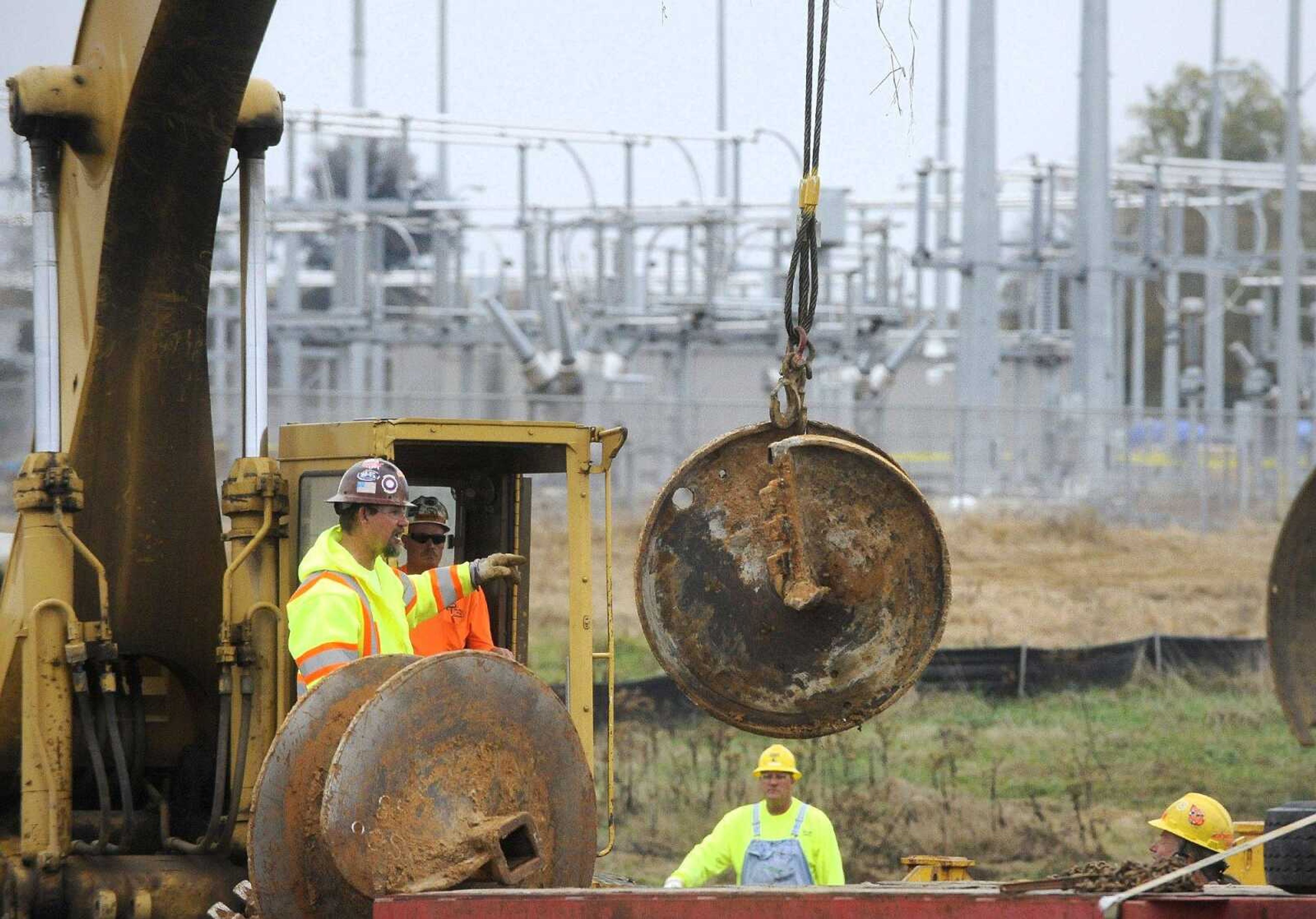 Workers load auger bits onto a flatbed after drilling out the placements in the ground Monday for a concrete foundation at the site of the new Ameren Missouri substation off Route K in Cape Girardeau County. (Laura Simon)