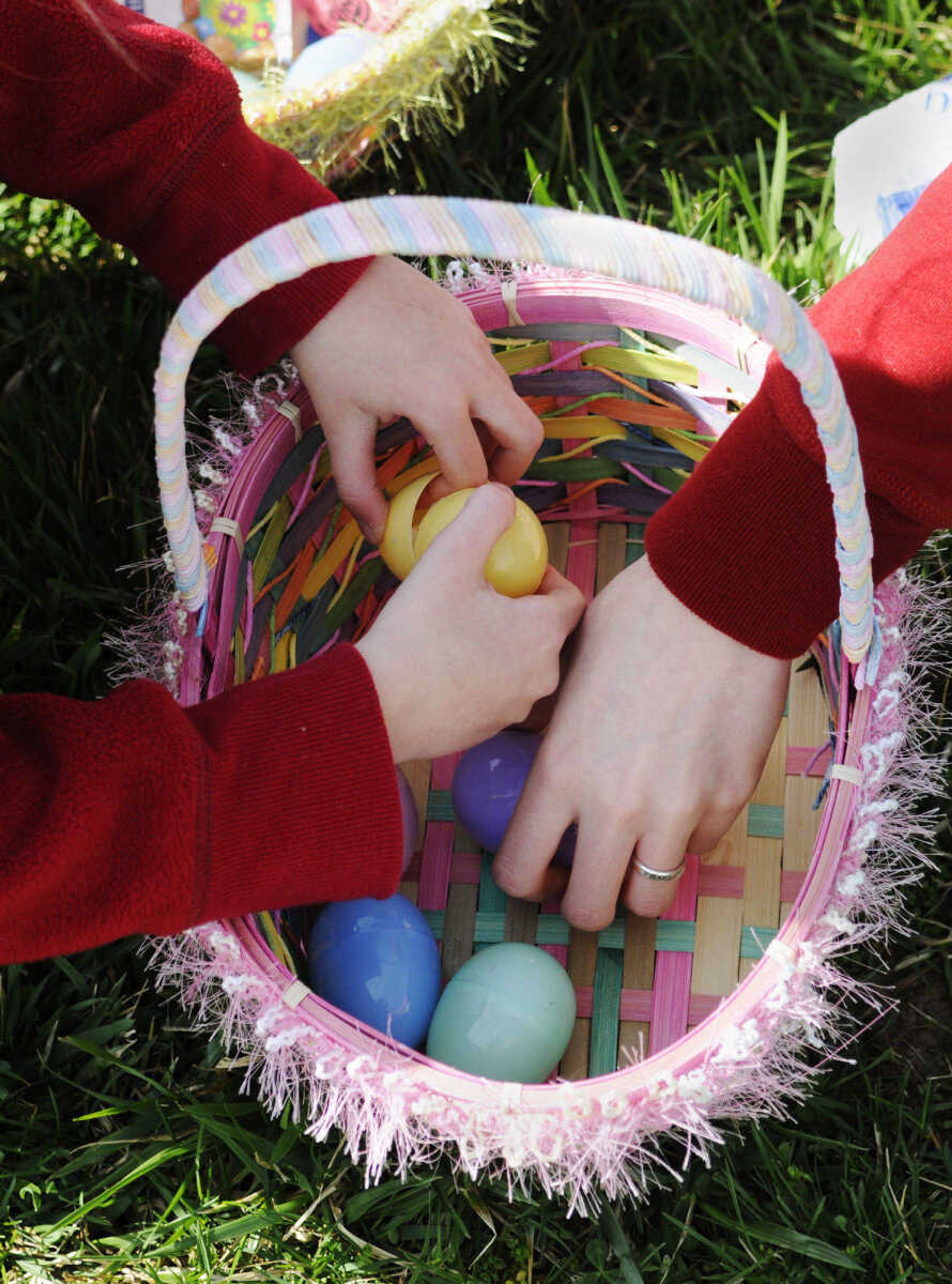 KRISTIN EBERTS ~ keberts@semissourian.com

Alexie McDonald, 6, left, sorts through the contents of her eggs with babysitter Krissie Daniel after the Cape Girardeau Parks and Recreation easter egg hunt at Kiwanis Park in Cape Girardeau, Mo., on Saturday, March 27, 2010.