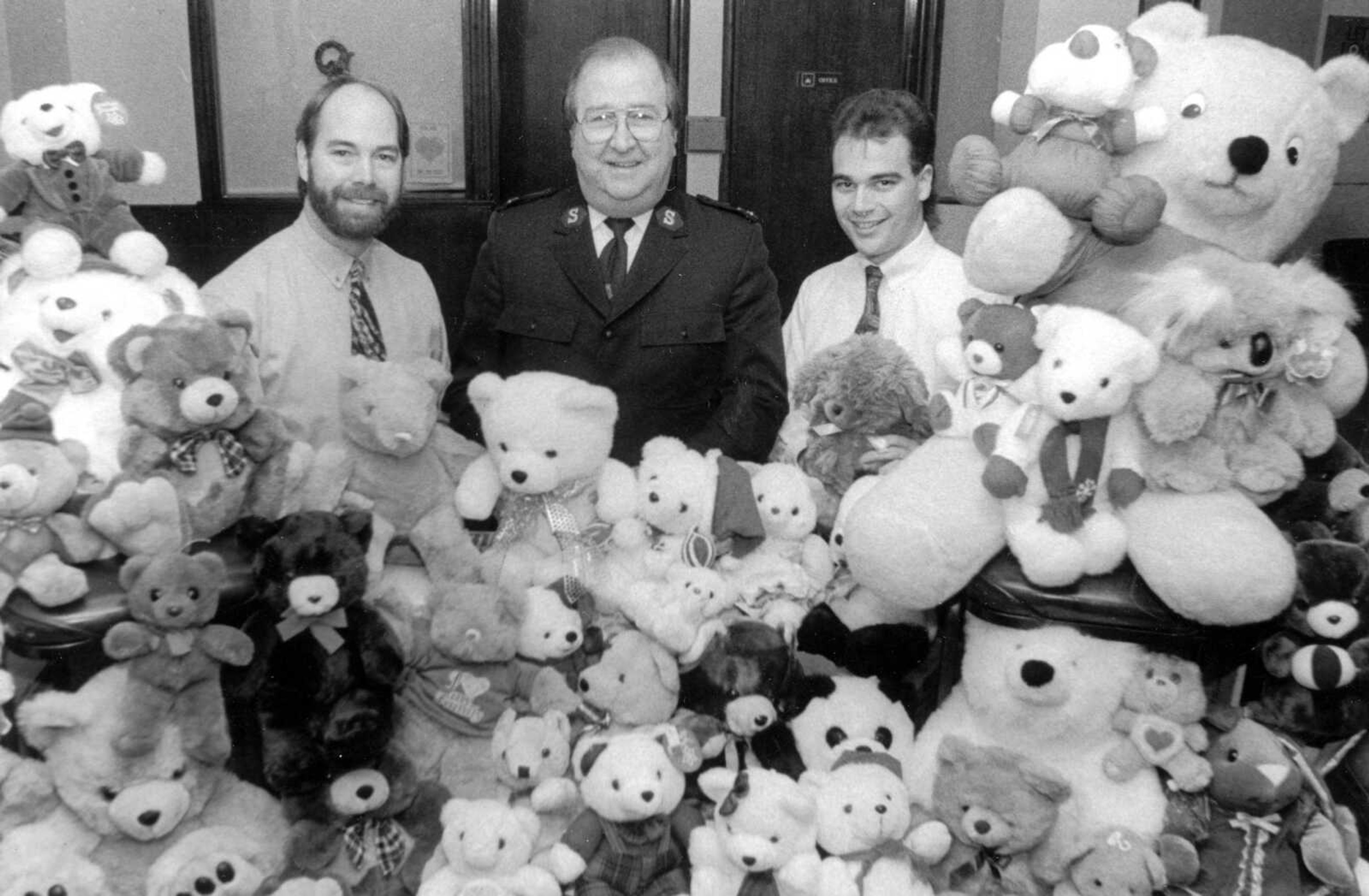 Published Dec. 20, 1992.
Cape Girardeau Salvation Army Capt. Elmer Trapp, center, poses with Cheekwood Studio owner Bill Cheek, left, and Cheekwood photographer Barry Gray after Cheekwood Studio customers donated 50 teddy bears for the Salvation Army's Toy Town. The customers received a free 4x5 portrait with no sitting fee for donating a bear. The bears will be distributed to less fortunate children at Christmas. (Southeast Missourian archive)