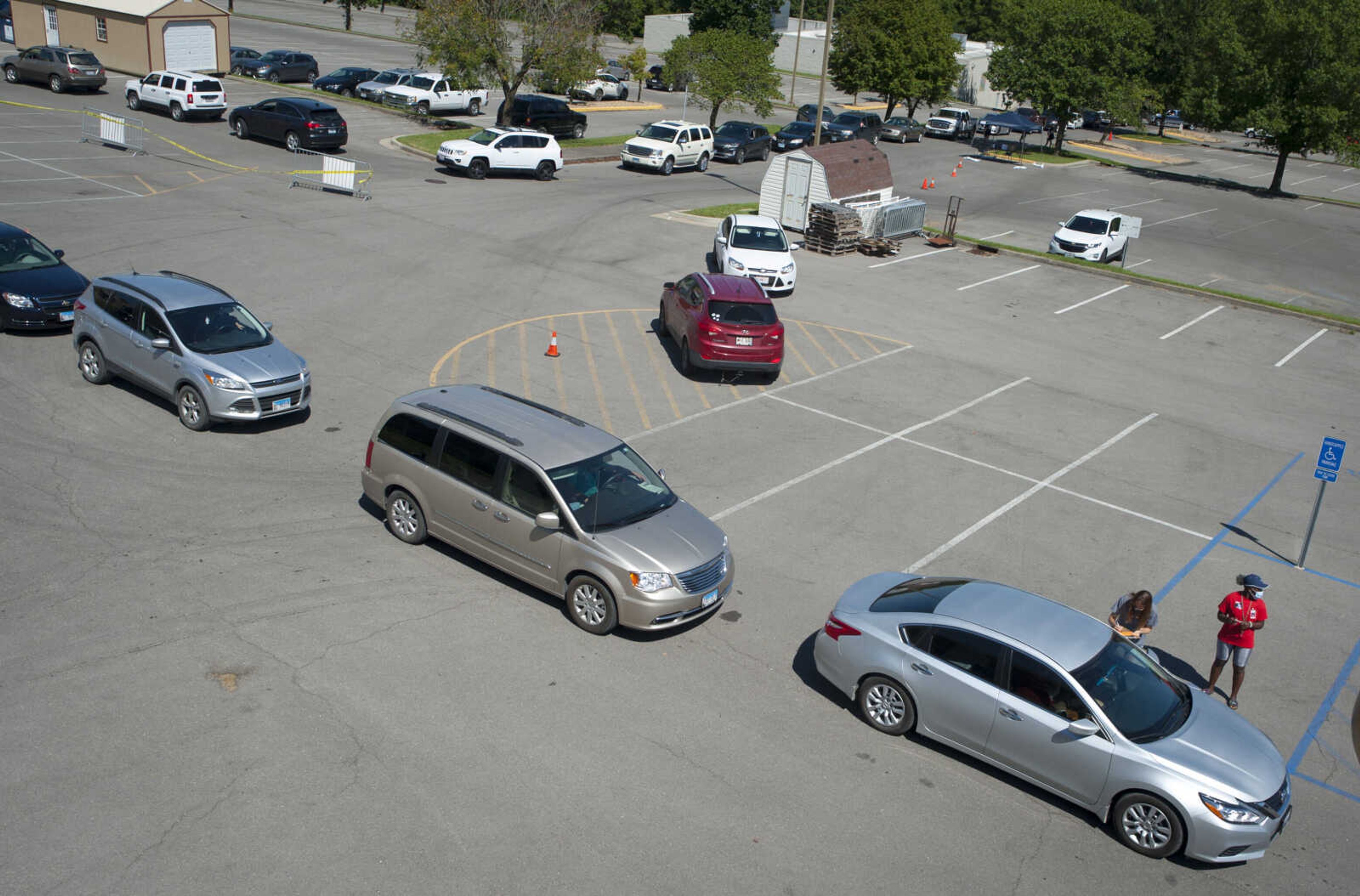 A line of cars snakes around the Show Me Center parking lot Wednesday, Aug. 19, 2020, at Southeast Missouri State University in Cape Girardeau during the first day of move-ins for new incoming students and new transfer students.