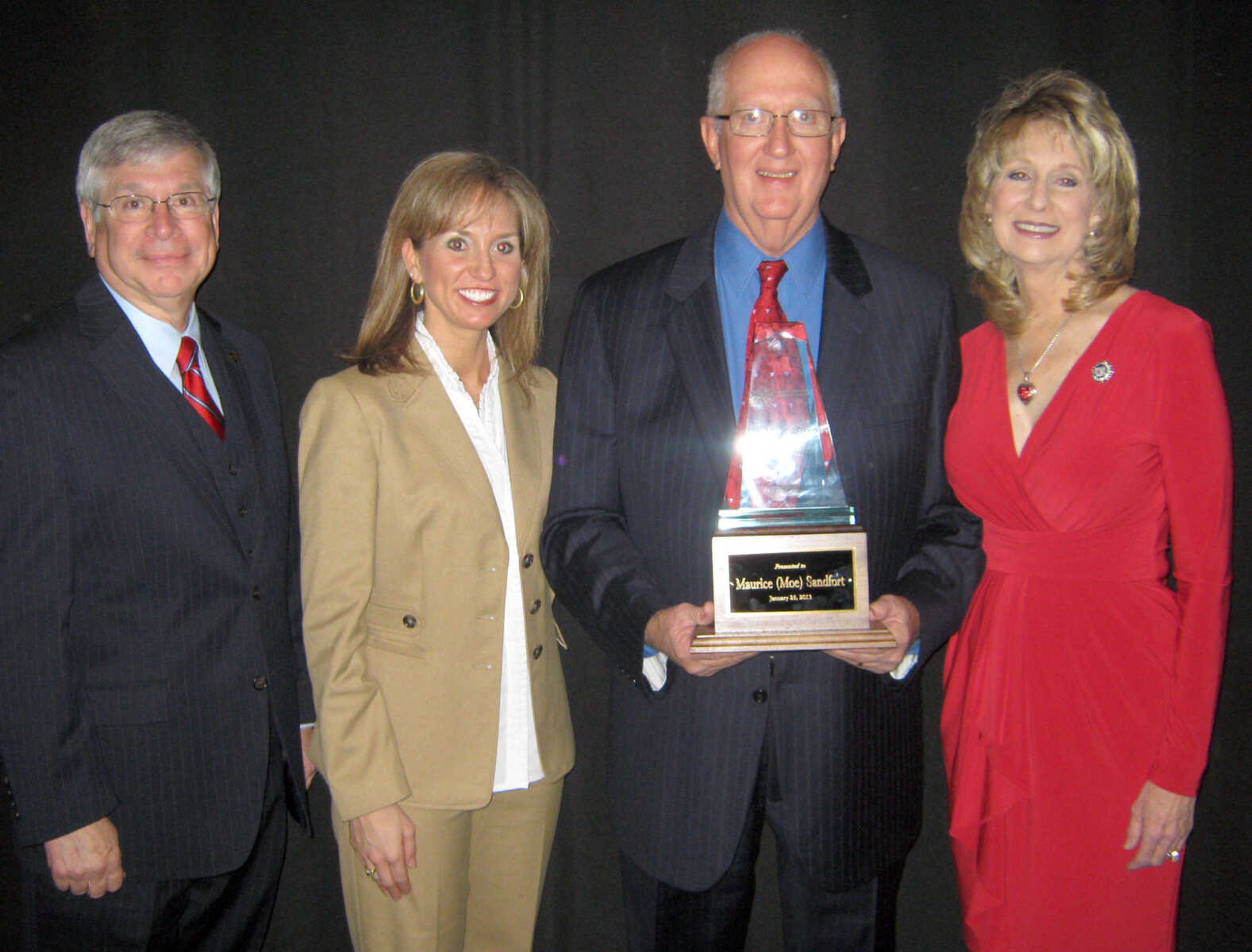 SHAY ALDERMAN ~ salderman@semissourian.com
Moe Sandfort receives the Rush H. Limbaugh Award of the Cape Girardeau Area Chamber of Commerce at its annual banquet Friday, Jan. 26, 2013 at the Show Me Center. Sandfort poses with state Sen. Wayne Wallingford, left, Rep. Shelley Keeney and Rep. Kathy Swan.