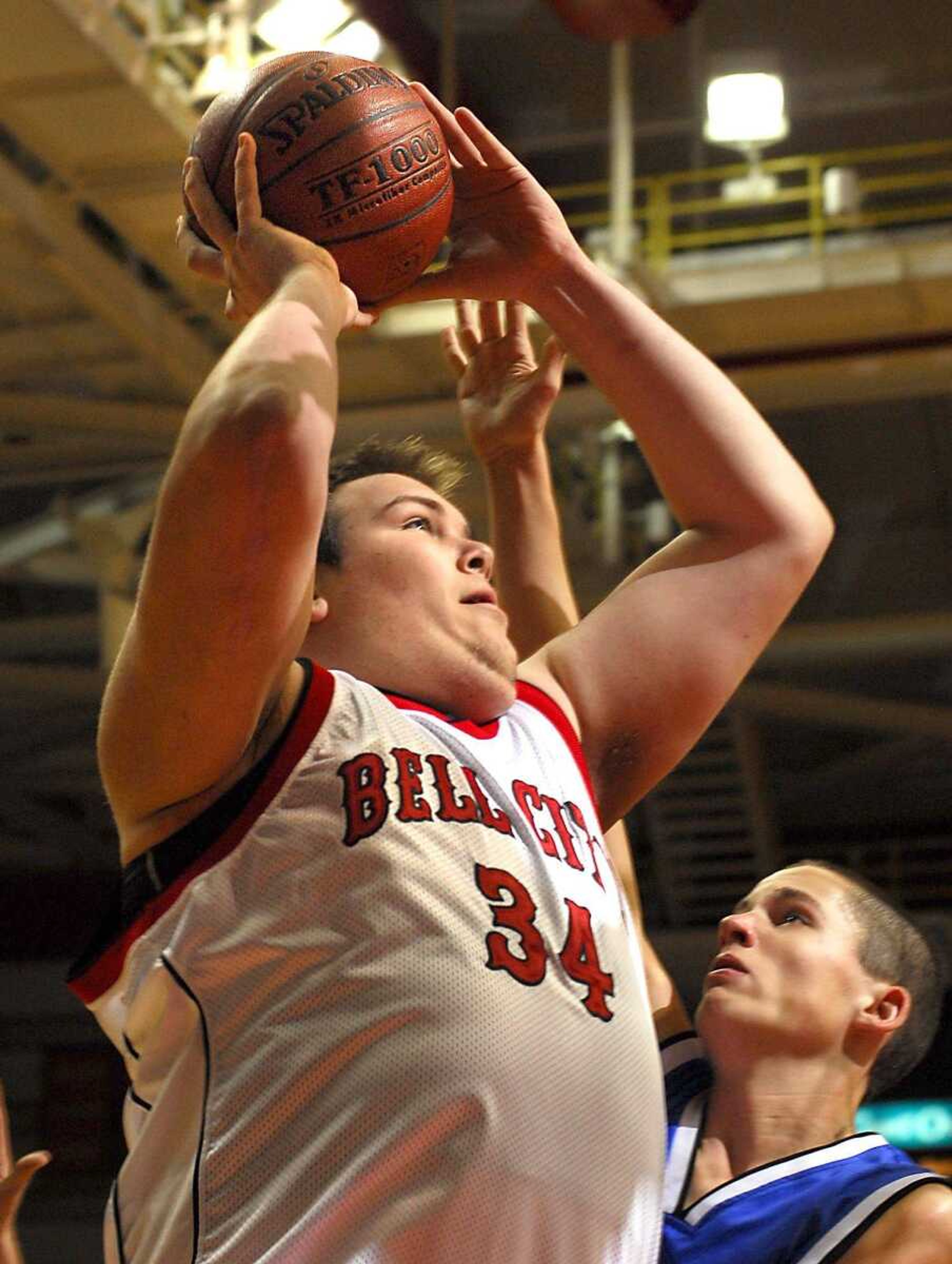 Bell City's Skylor Blackler shot over Oak Ridge's Logan Mangels in the first quarter Wednesday at the Southeast Missourian Christmas Tournament. Blackler, the tallest player in the field of 16 teams at 7 feet, 1 inch, helped the defending champions to a 75-39 victory in the first round. (Fred Lynch)