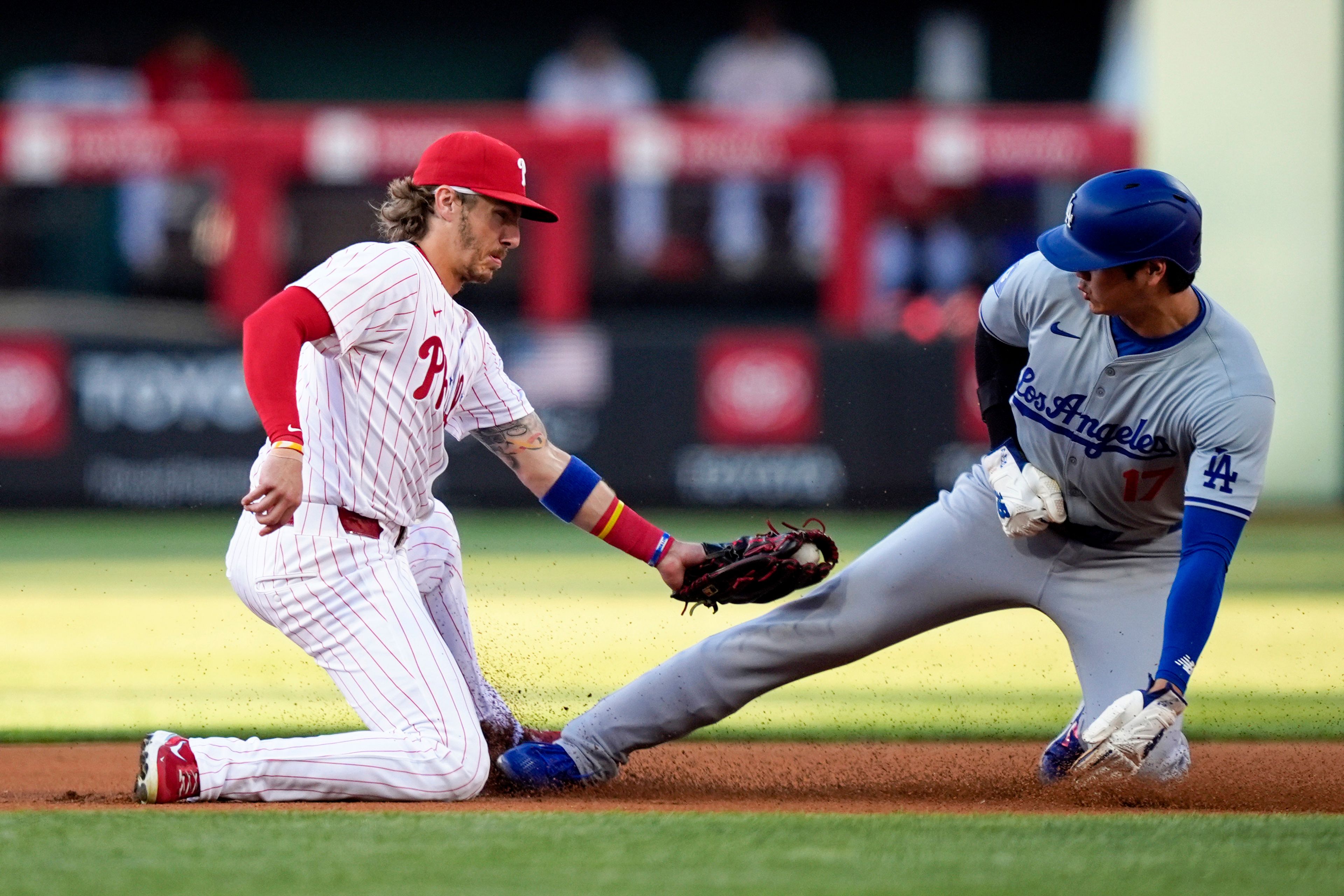 Los Angeles Dodgers' Shohei Ohtani, right, steals second past Philadelphia Phillies second baseman Bryson Stott during the first inning of a baseball game, Wednesday, July 10, 2024, in Philadelphia. (AP Photo/Matt Slocum)