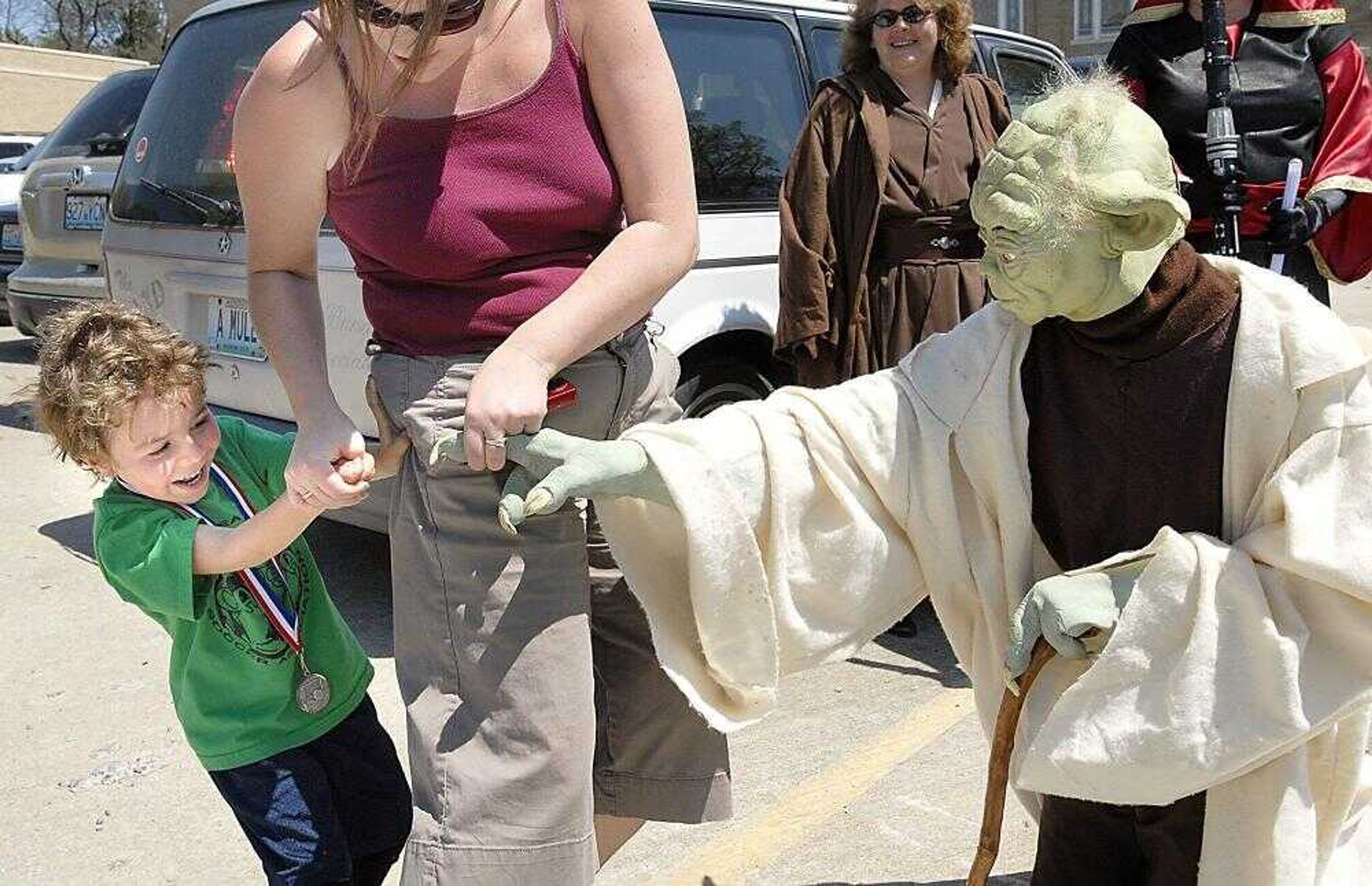 Nikolaos Demopoulos shields himself from a Yoda impersonator at the comic convention at the Student Recreation Center-South on Saturday, April 21, 2007, while his mother Autumn Deomopoulos tries to introduce the two. (Kit Doyle)