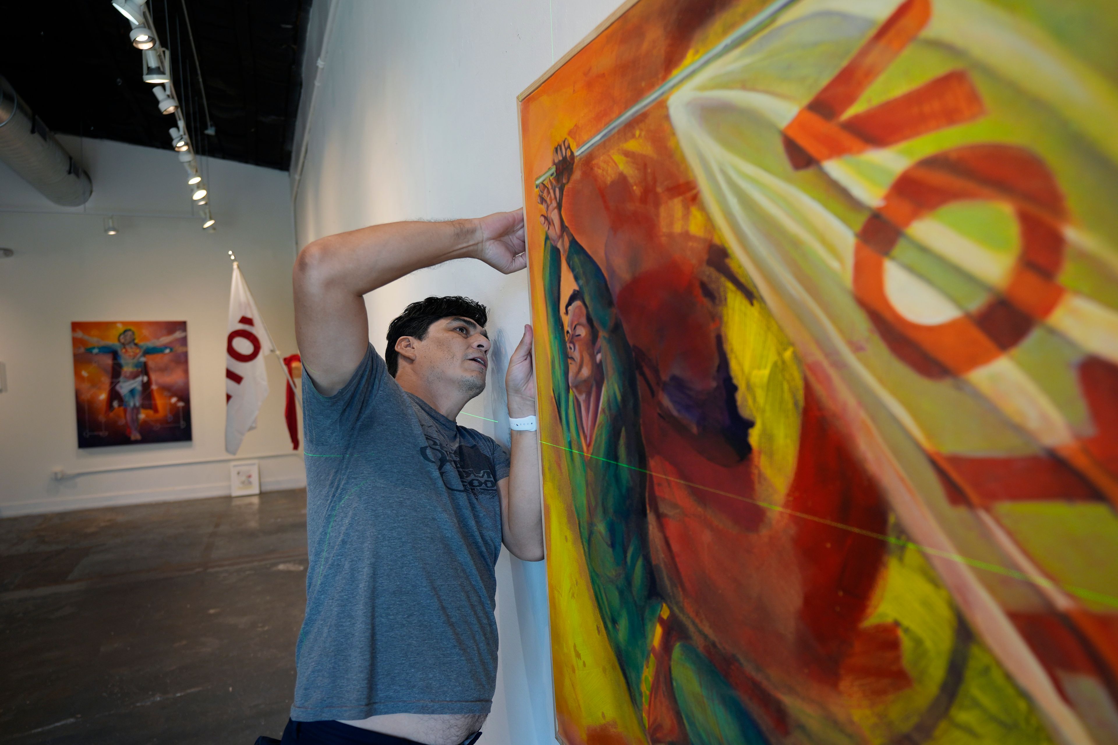 Artist David Alcantar prepares works of art from his "Superman Project" for an upcoming show in San Antonio, Tuesday, Oct. 1, 2024. (AP Photo/Eric Gay)