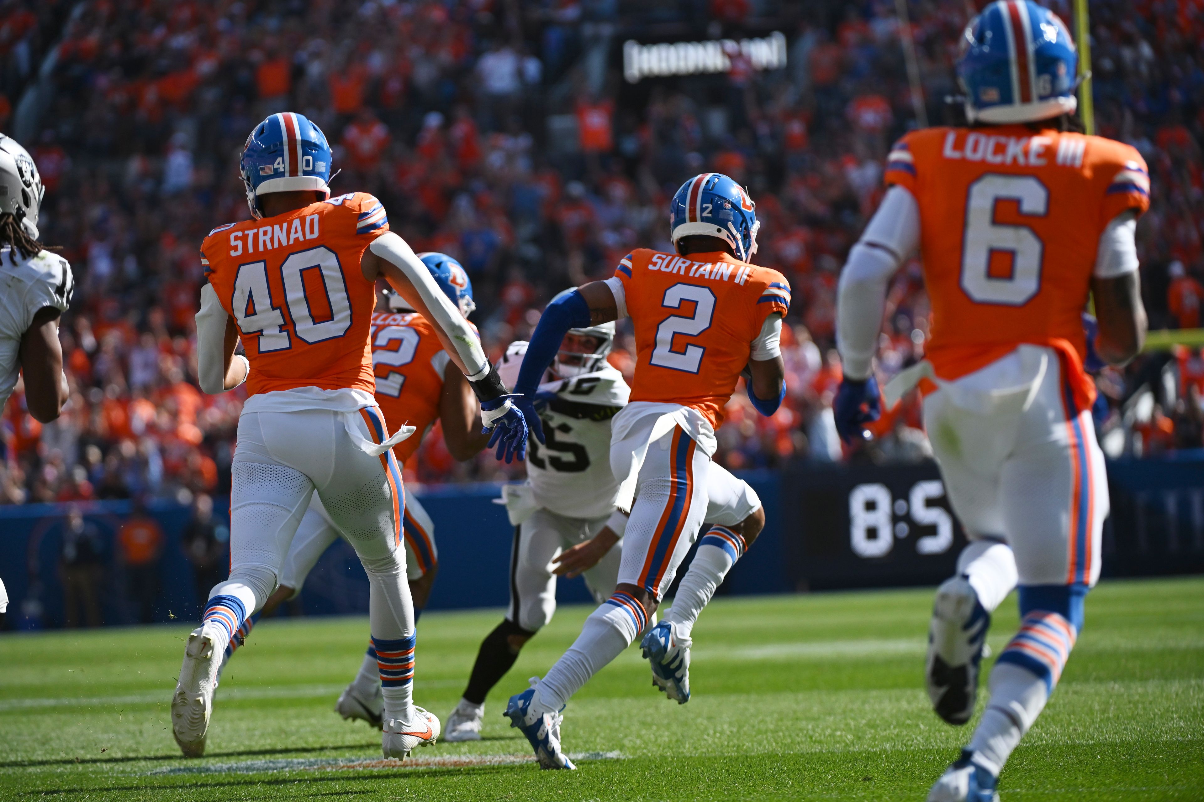 Denver Broncos cornerback Pat Surtain II (2) intercepts a pass and returns it for a 100-yard touchdown during the first half of an NFL football game against the Las Vegas Raiders, Sunday, Oct. 6, 2024, in Denver. (AP Photo/Geneva Heffernan)