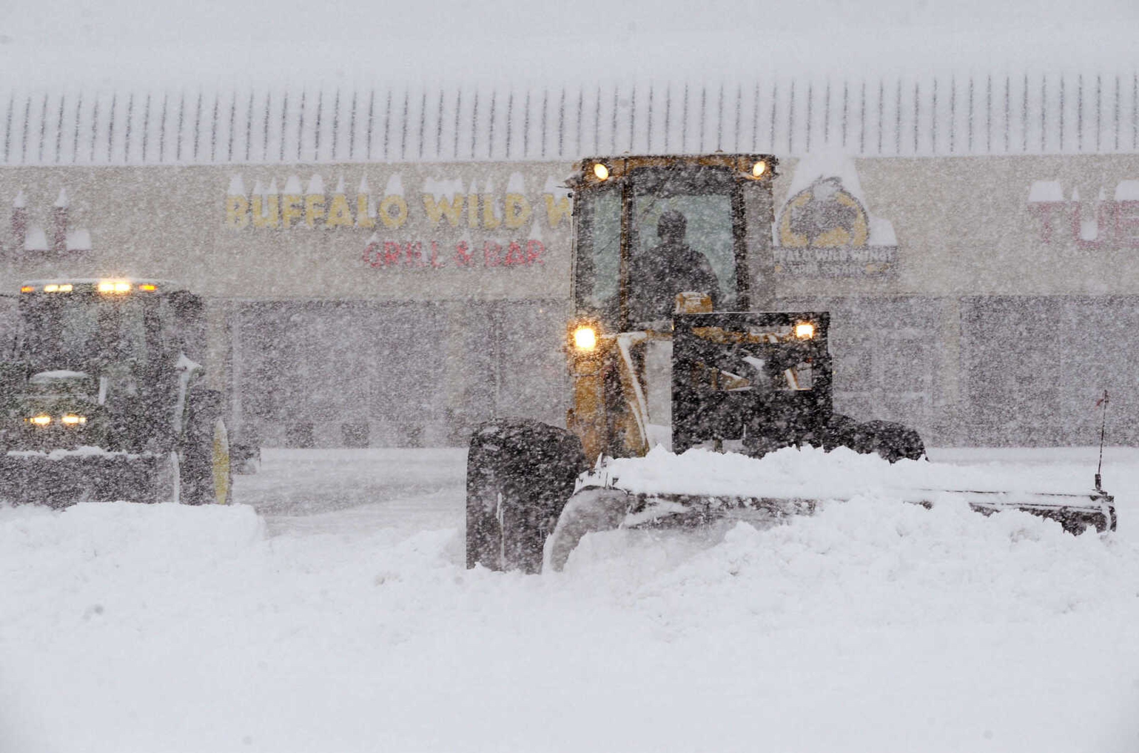 FRED LYNCH ~ flynch@semissourian.com
Snow plows work in the Town Plaza parking lot Monday morning, Feb. 16, 2015 in Cape Girardeau.