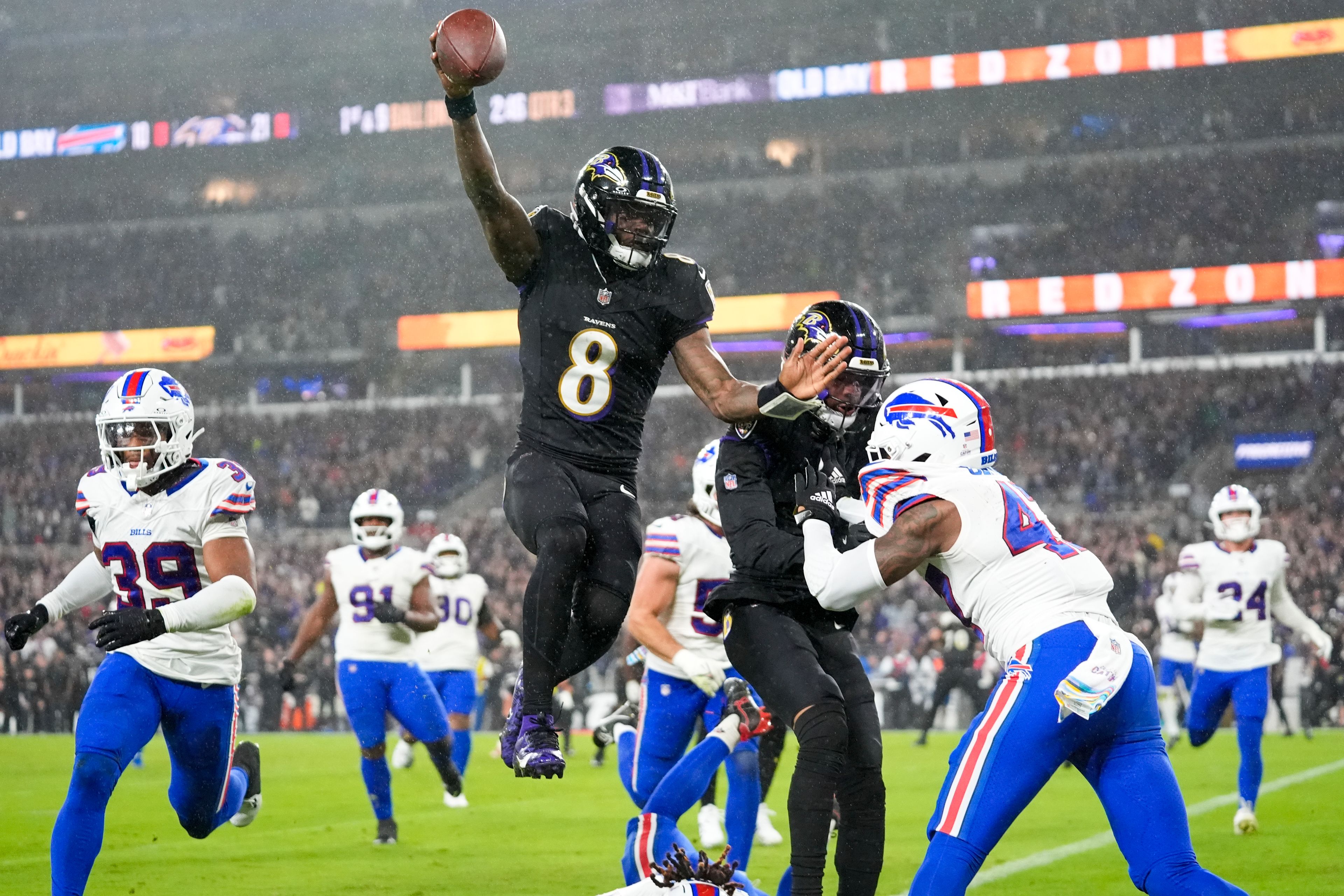 Baltimore Ravens quarterback Lamar Jackson (8) scores a touchdown against the Buffalo Bills during the second half of an NFL football game, Sunday, Sept. 29, 2024, in Baltimore. (AP Photo/Stephanie Scarbrough)