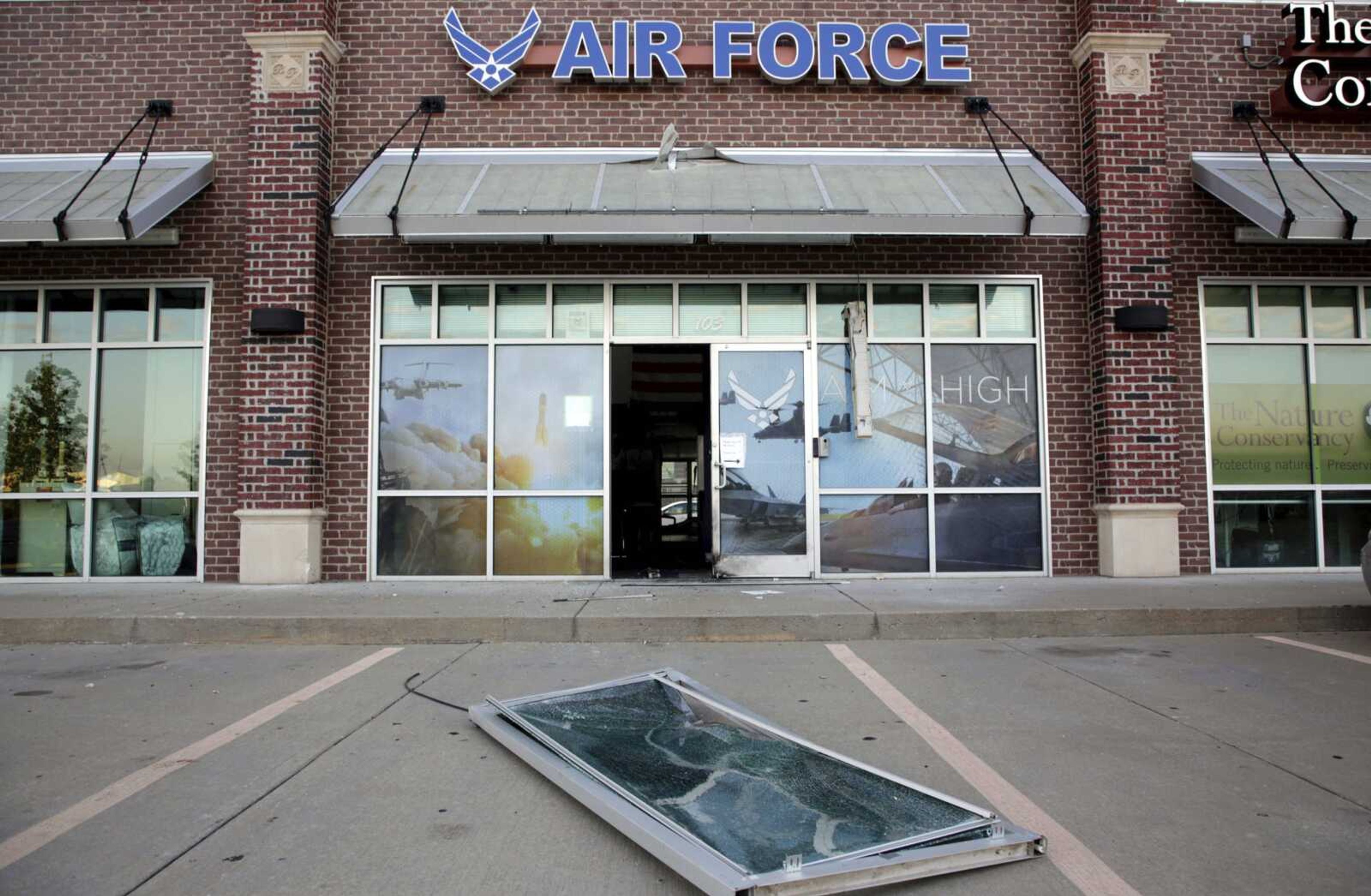 Glass and a door lie on the ground at the scene of an explosion at an Air Force recruiting office in Bixby, Oklahoma, after an explosion Monday night outside an Air Force recruitment office. The center was closed at the time, and no one was injured.