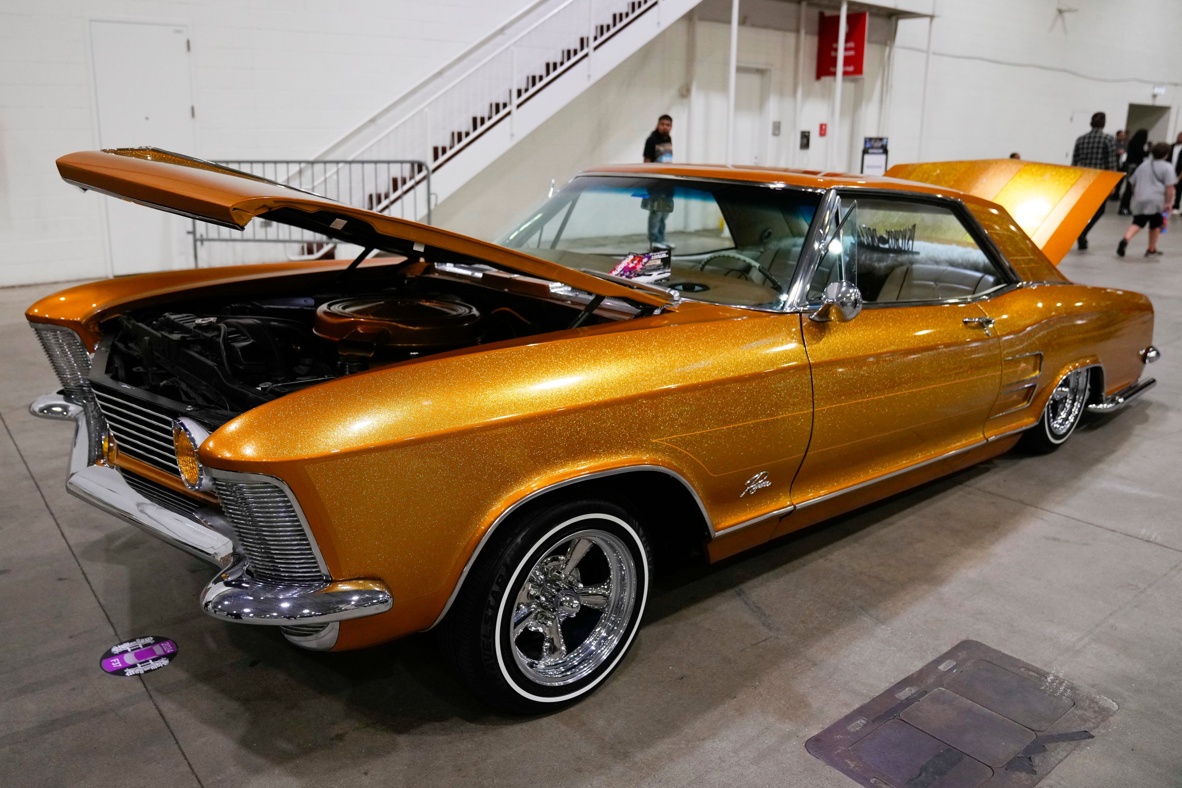 A gold lowrider car is on display at the Slow & Low Chicago Lowrider Festival, Saturday, Oct. 12, 2024, at Navy Pier in Chicago. (AP Photo/Erin Hooley)