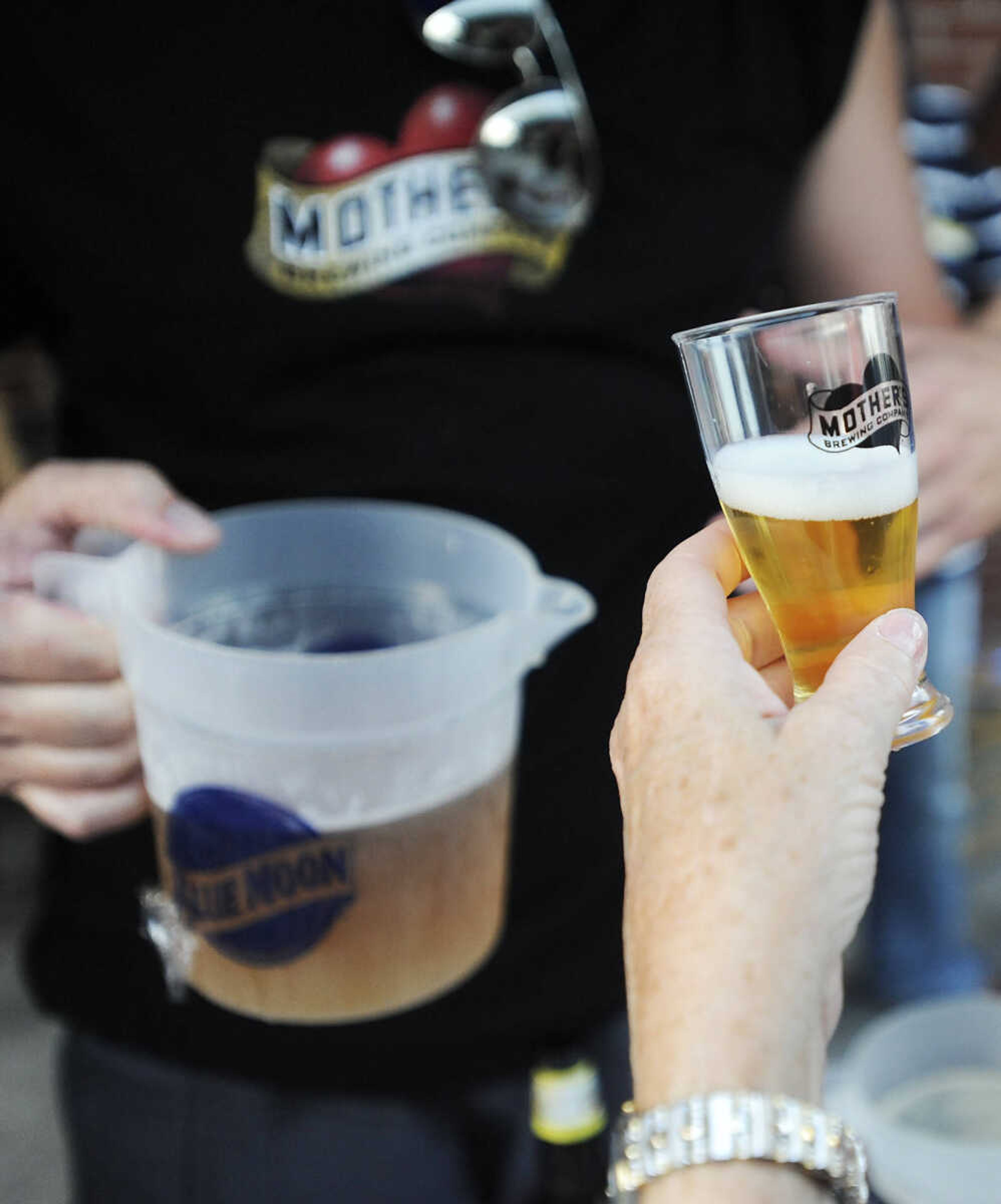 ADAM VOGLER ~ avogler@semissourian.com
Mother's Brewing Company Promotional Manager Shawn Seabaugh pours one of the Springfield brewery's offerings at Red, White and Brewfest Friday, July 20, at the Bel Air Grill. The event featured food, samples from several breweries and music by The Theory.