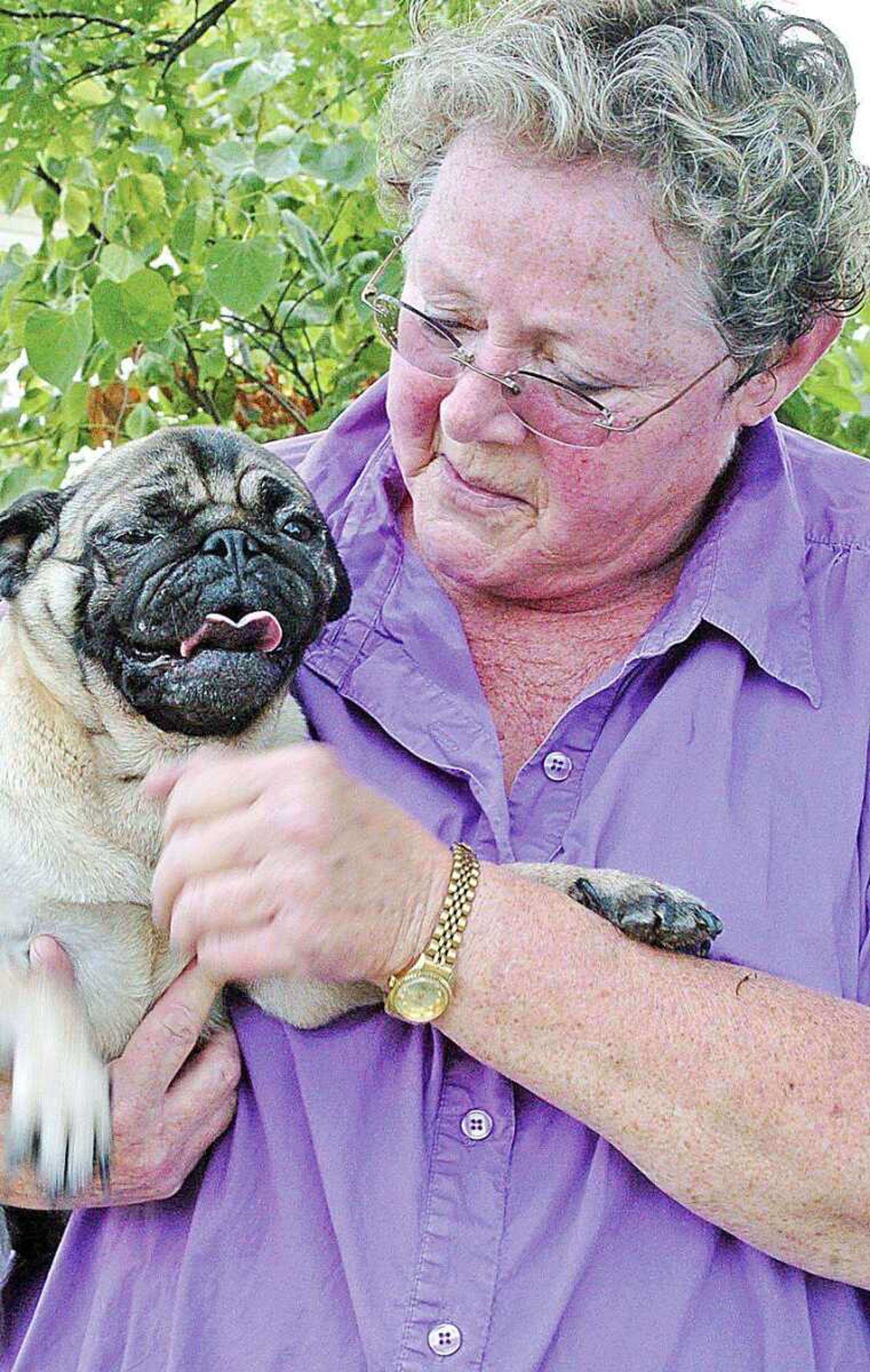 Laura Holloway holds one of the dogs saved by SEMO Animal Rescue Alliance. The group rescues dogs which are about to be killed and finds new homes for them. (JILL BOCK ~ Standard Democrat)