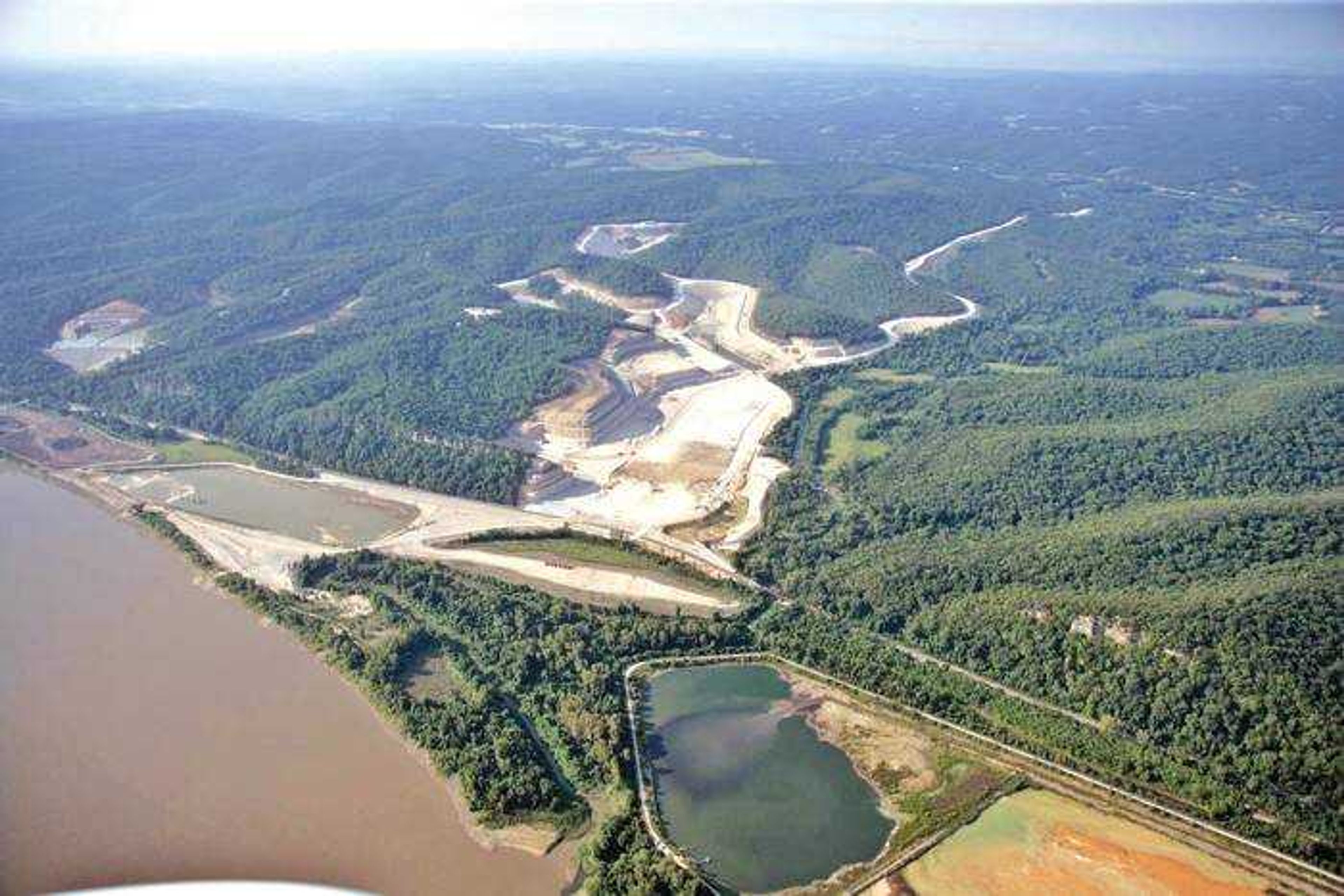 This aerial photo shows the initial footprint of the cement plant. The access road is at the right and leads to the site preparation area. A harbor will also be built. (Photo by Holcim (US) Inc.)