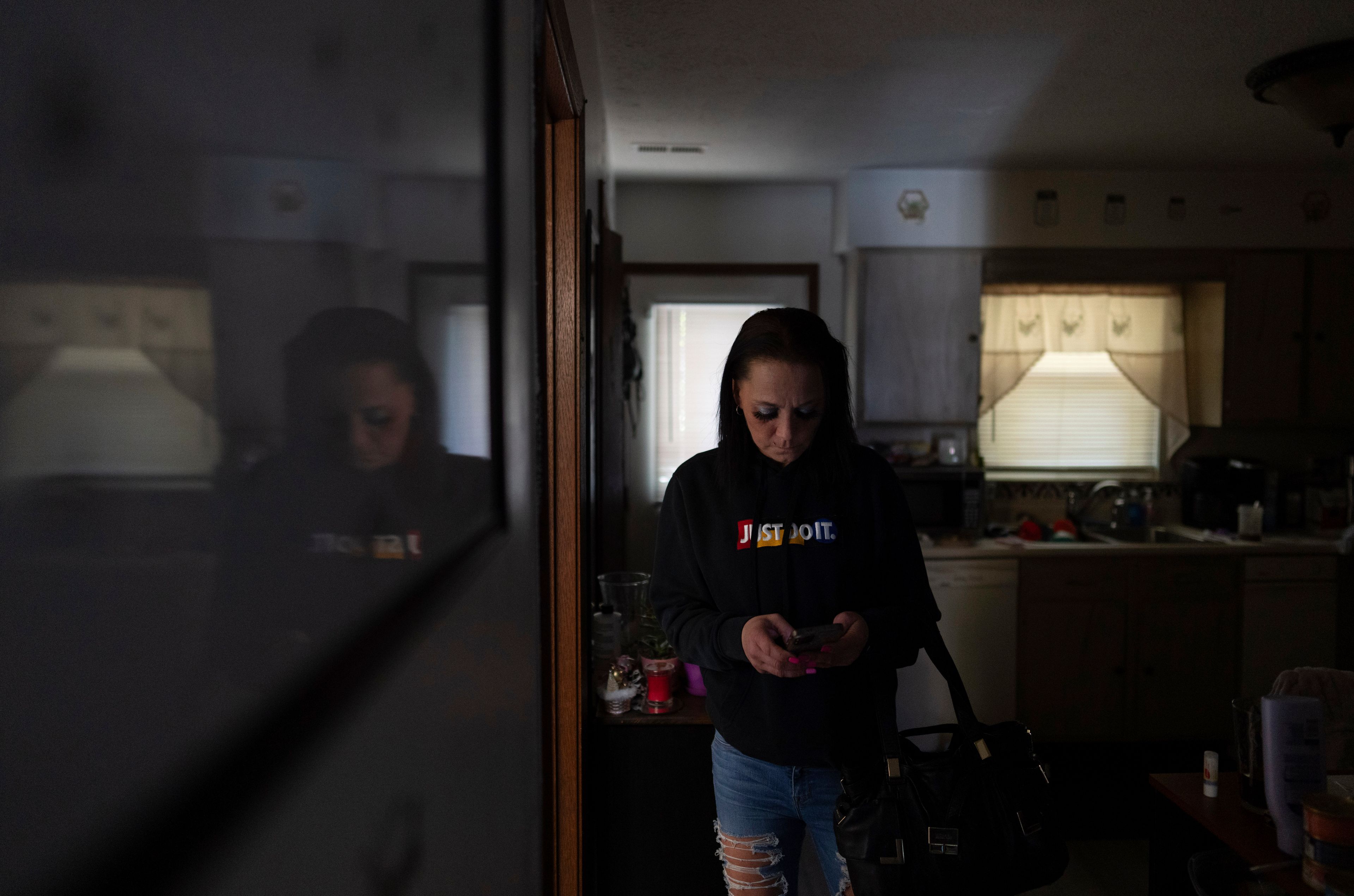 April Youst looks at her phone as she prepares to leave her West Virginia home on Wednesday, Oct. 9, 2024. (AP Photo/Carolyn Kaster)