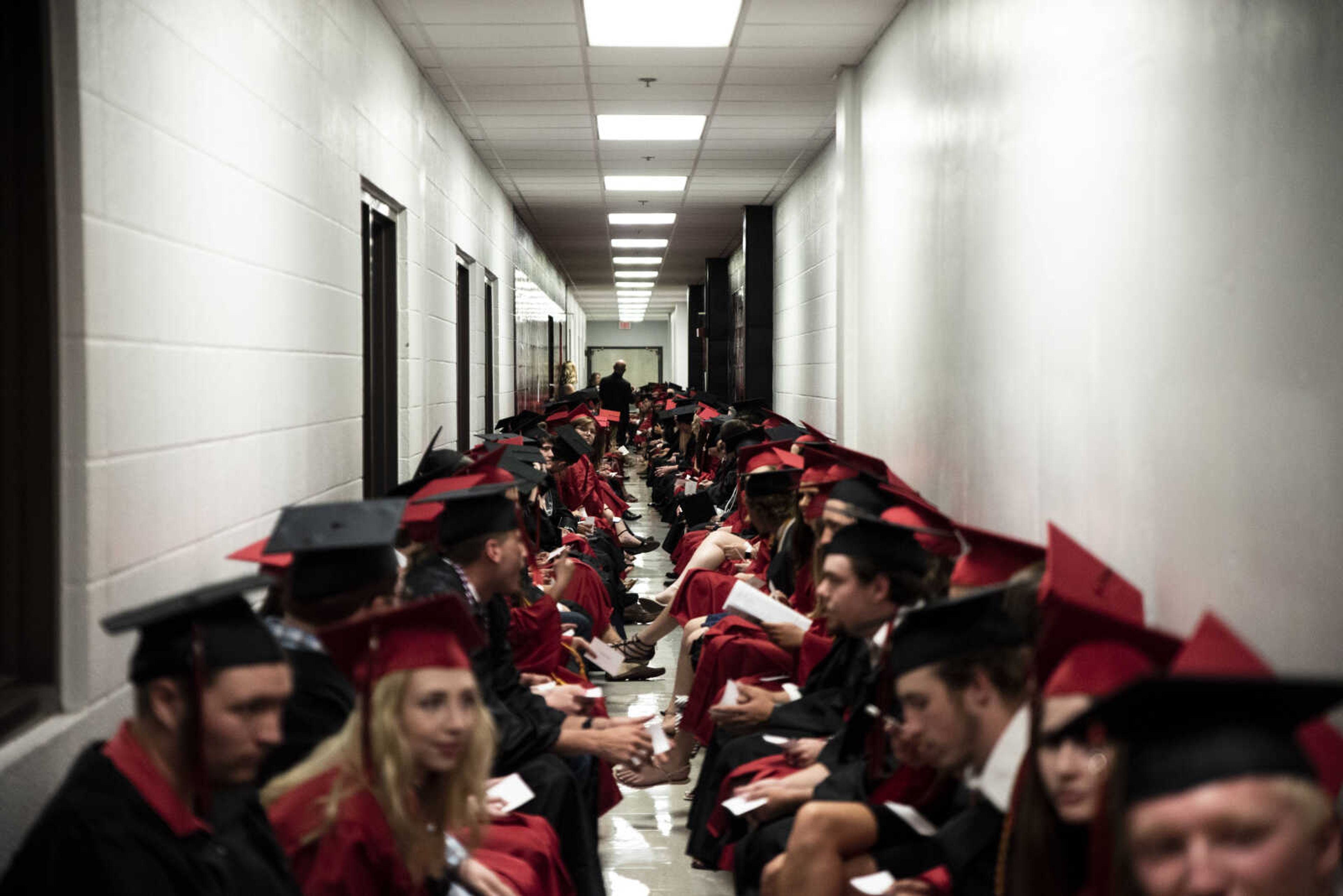 Graduates sit in their seats while waiting in the back tunnels of the Show Me Center before processing in during the Jackson High School Class of 2019 Commencement at the Show Me Center Friday, May 24, 2019, in Cape Girardeau.