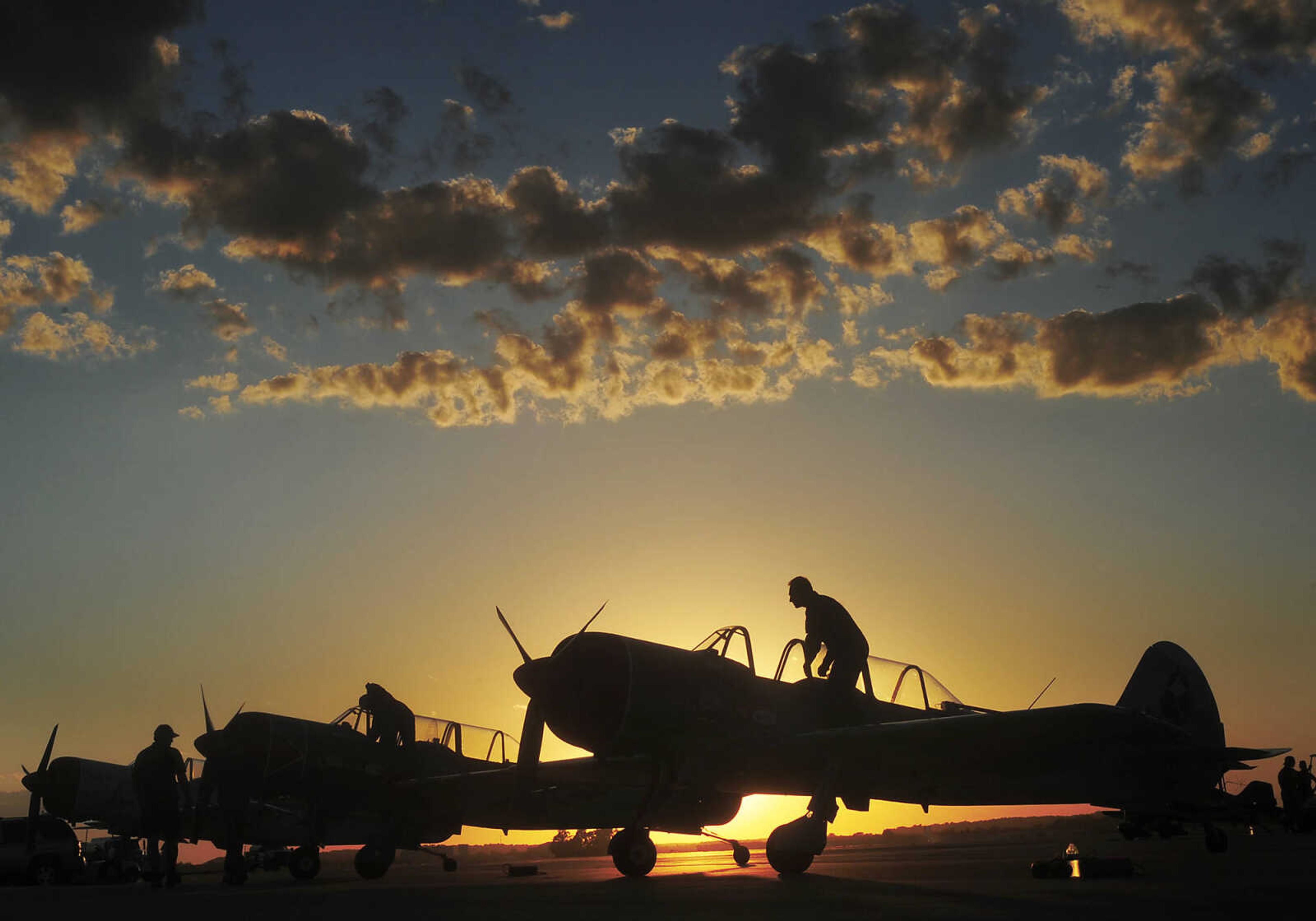 ADAM VOGLER ~ avogler@semissourian.com
The Aerostars Aerobatics Team board their Yak 52 TW aircraft before performing at the 2013 Cape Girardeau Regional Air Festival Friday, June 28, at the Cape Girardeau Regional Airport. The World War II era aerobatic trainers used by the precision aerobatic team were designed by the former Soviet Union and built in Romania. They are powered by a 400 horsepower supercharged radial engine.