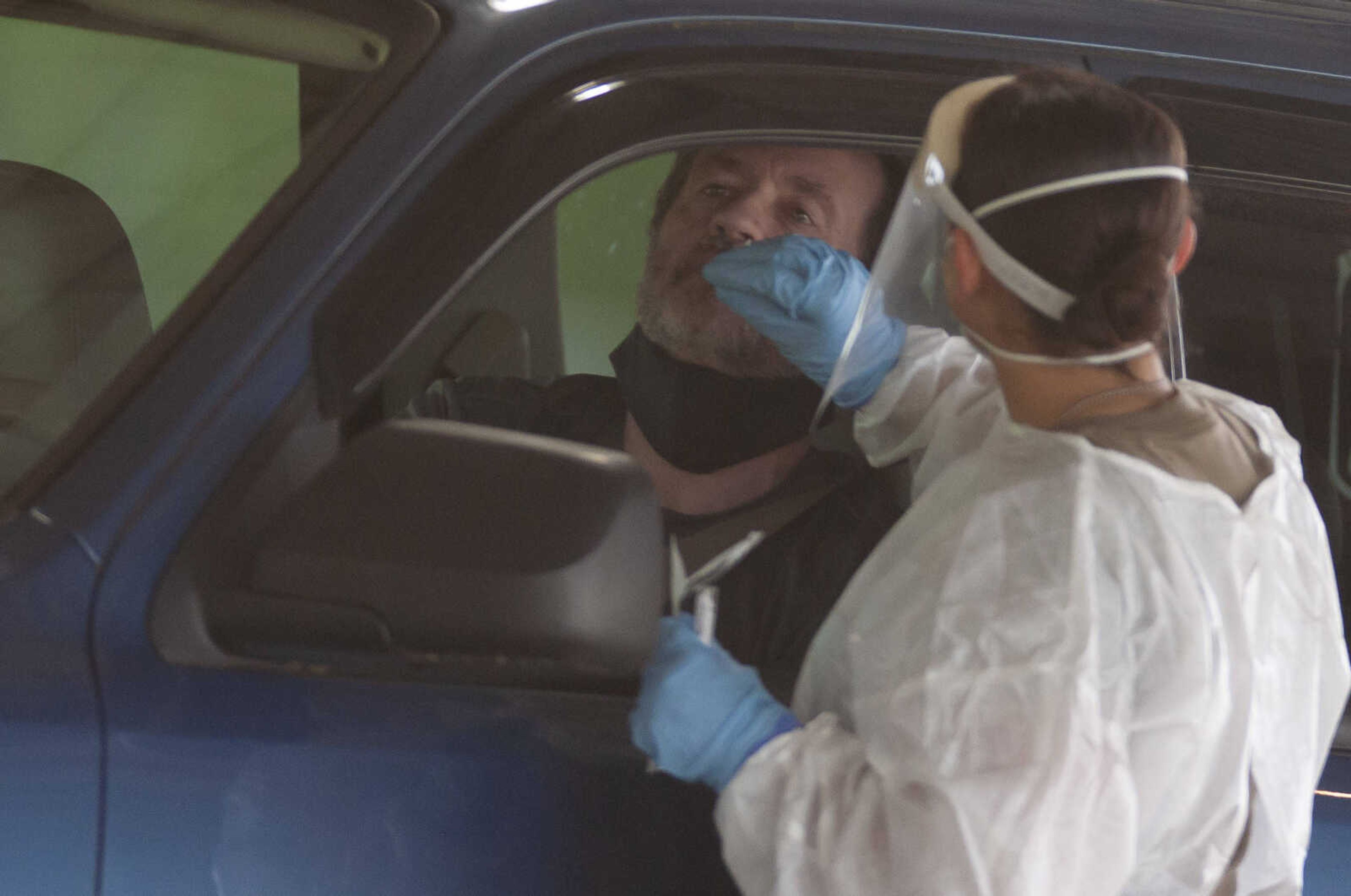 Southeast Missourian reporter Jeff Long has a nasal swab performed by Kristen Arroyo, a private first class with the Missouri Army National Guard, during free COVID-19 testing Friday, June 5, 2020, at Arena Park in Cape Girardeau. The drive-through testing event was scheduled for 7 a.m. to 7 p.m.