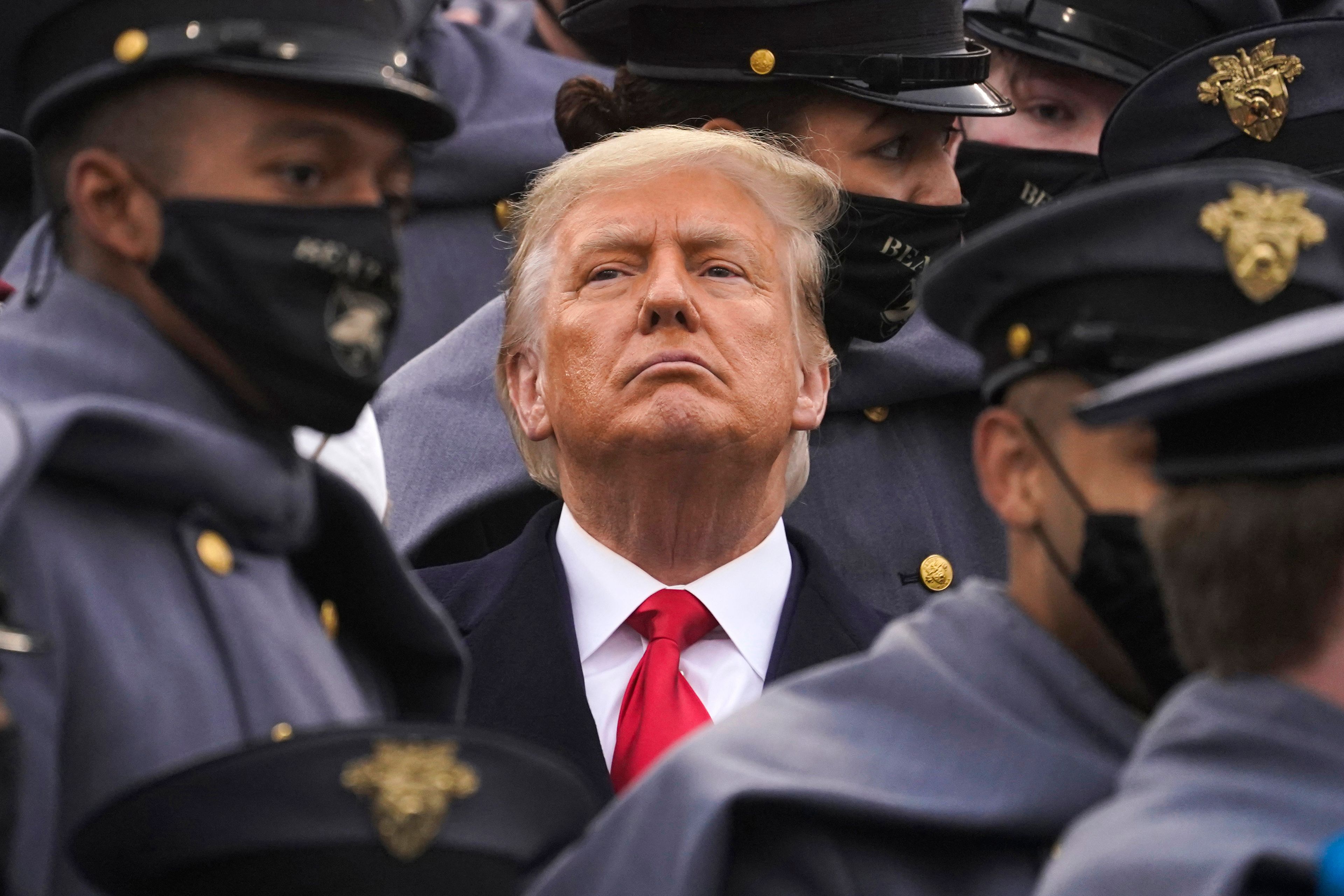 FILE - Surrounded by Army cadets, President Donald Trump watches the first half of the 121st Army-Navy Football Game, Dec. 12, 2020, in West Point, N.Y. (AP Photo/Andrew Harnik, File)