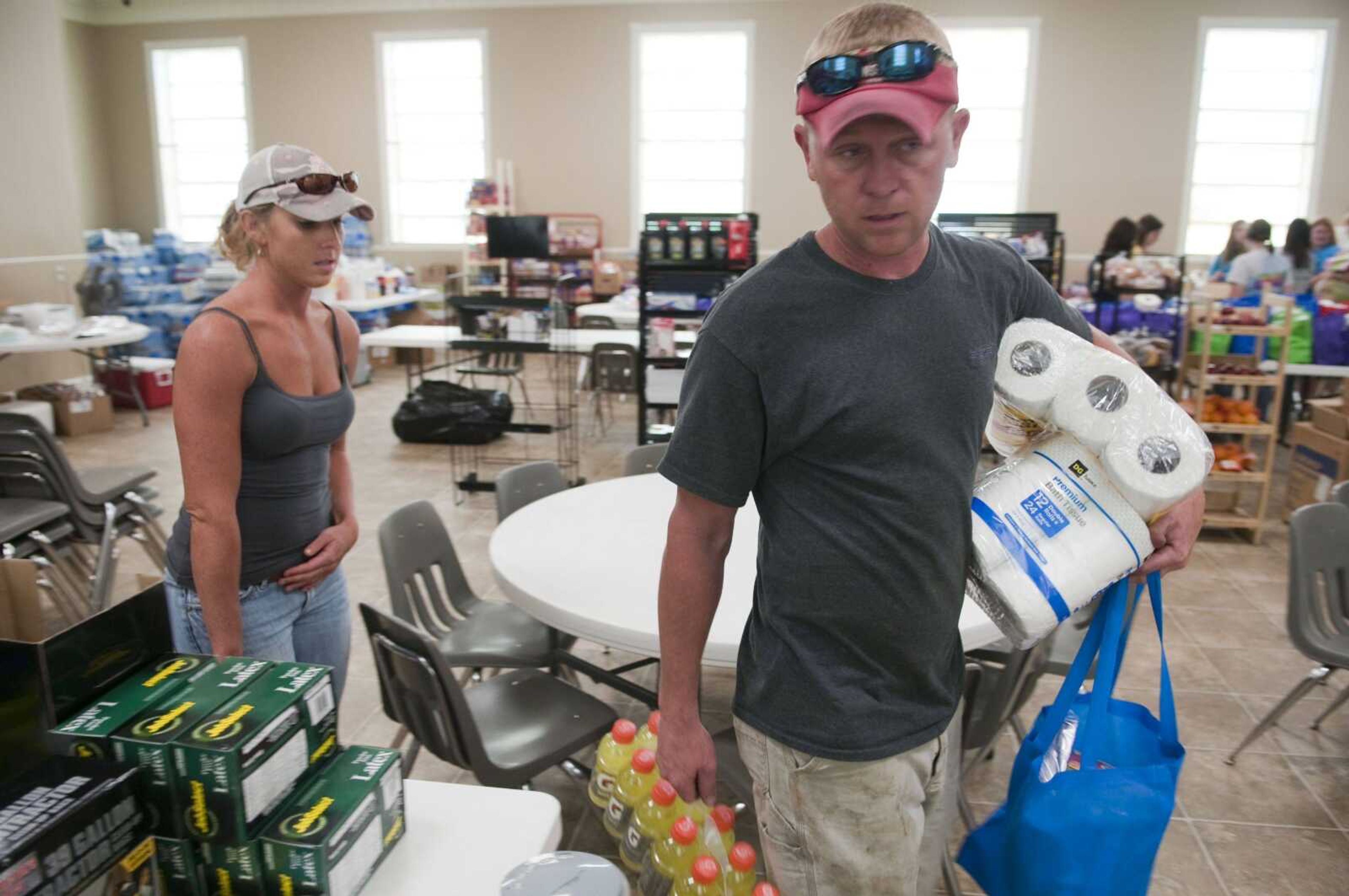 Katy Webb, left, and B.J. Cook of Pleasant Grove, Ala., pick up supplies for Webb's uncle Monday at Union Hill Baptist Church in Concord, Ala. Her uncle's home was damaged during a tornado last week. (Bob Farley ~ Associated Press)