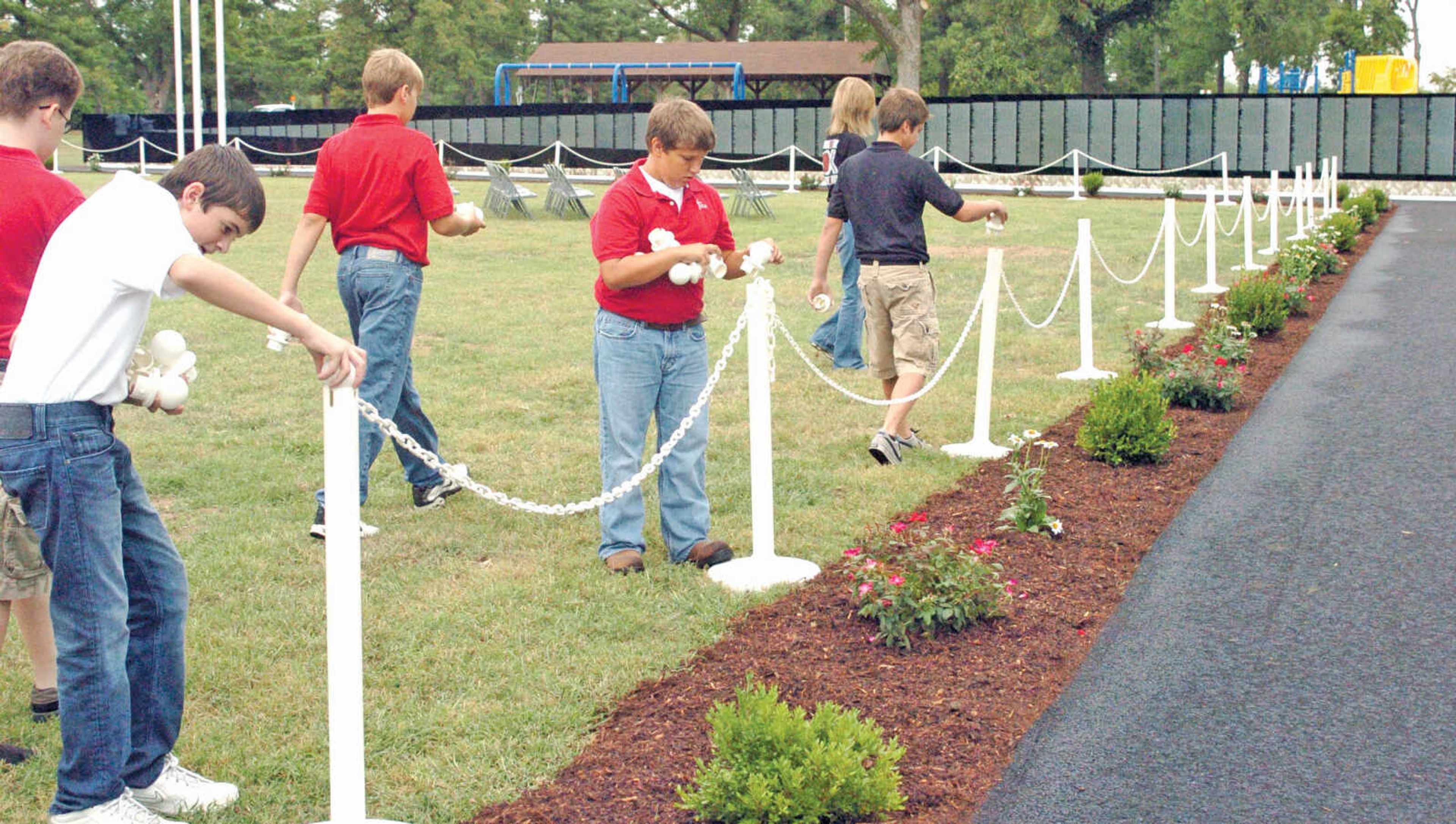 Seventh and eighth grade students form St. Eustachius Catholic School in Portageville volunteered to help set up the Moving Wall Thursday at Sikeston's Rotary Park. The Wall is open and can be viewed anytime until 4 p.m. Monday. (Jill Bock/Standard Democrat)