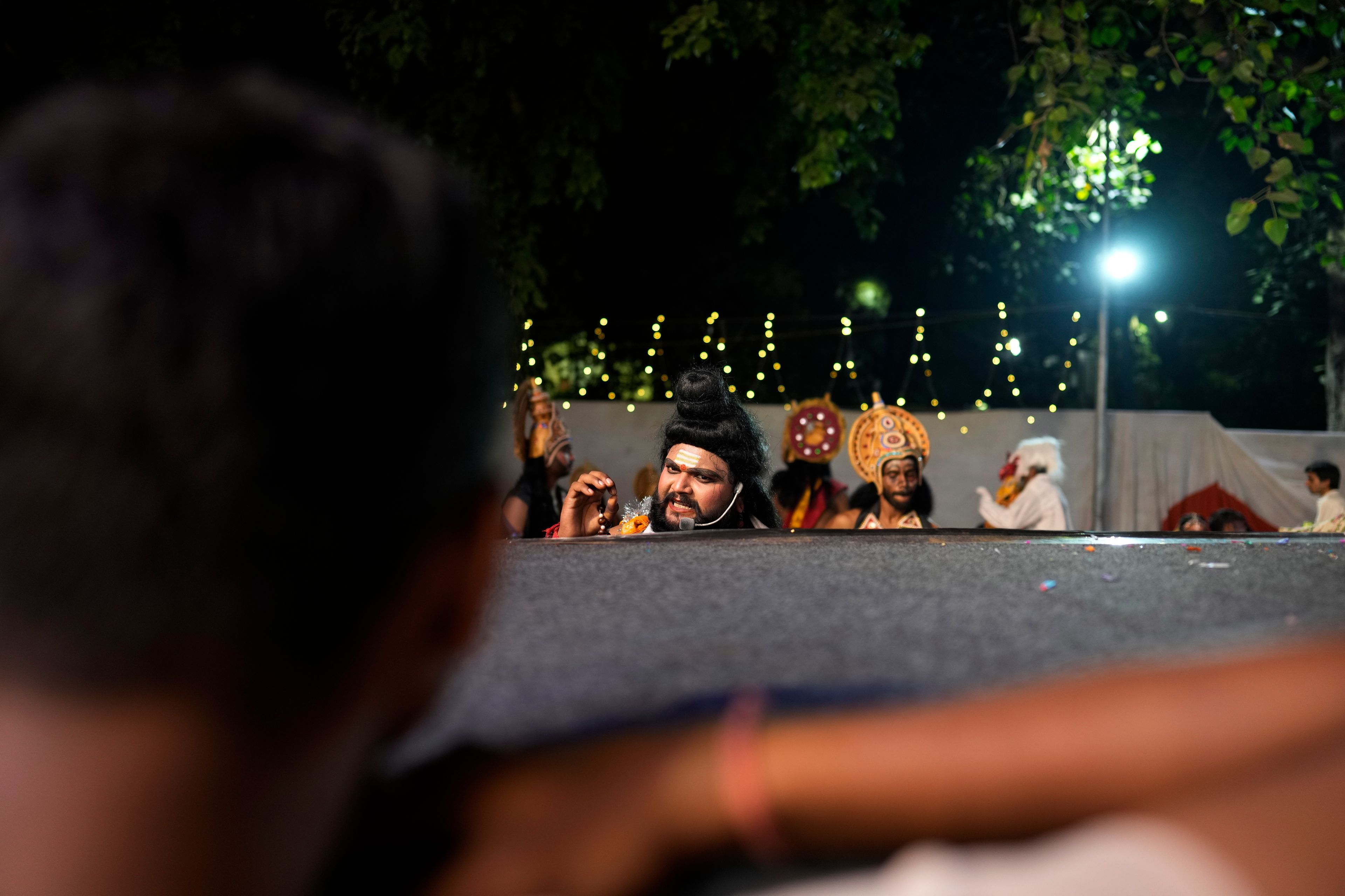 An actor takes directions backstage before the start of Ramleela, a dramatic folk re-enactment of the life of Hindu god Rama according to the ancient Hindu epic Ramayana, in New Delhi, India, Wednesday, Oct. 9, 2024. (AP Photo/Manish Swarup)