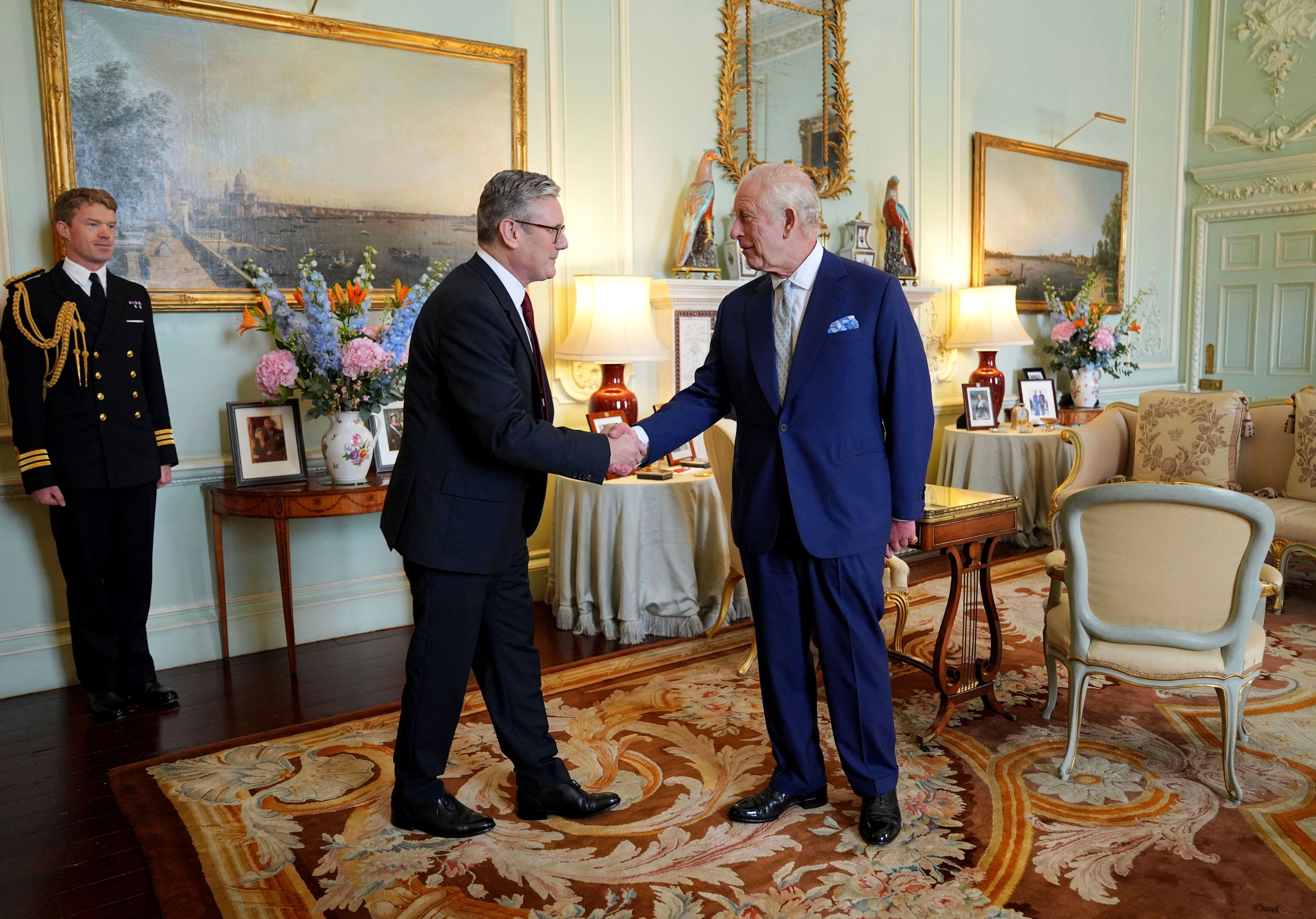 FILE - Britain's King Charles III, right, shakes hands with Keir Starmer where he invited the Labour Party leader to become prime minister and to form a new government, following the landslide general election victory for the Labour Party, in London, Friday, July 5, 2024. (Yui Mok, Pool Photo via AP, File)