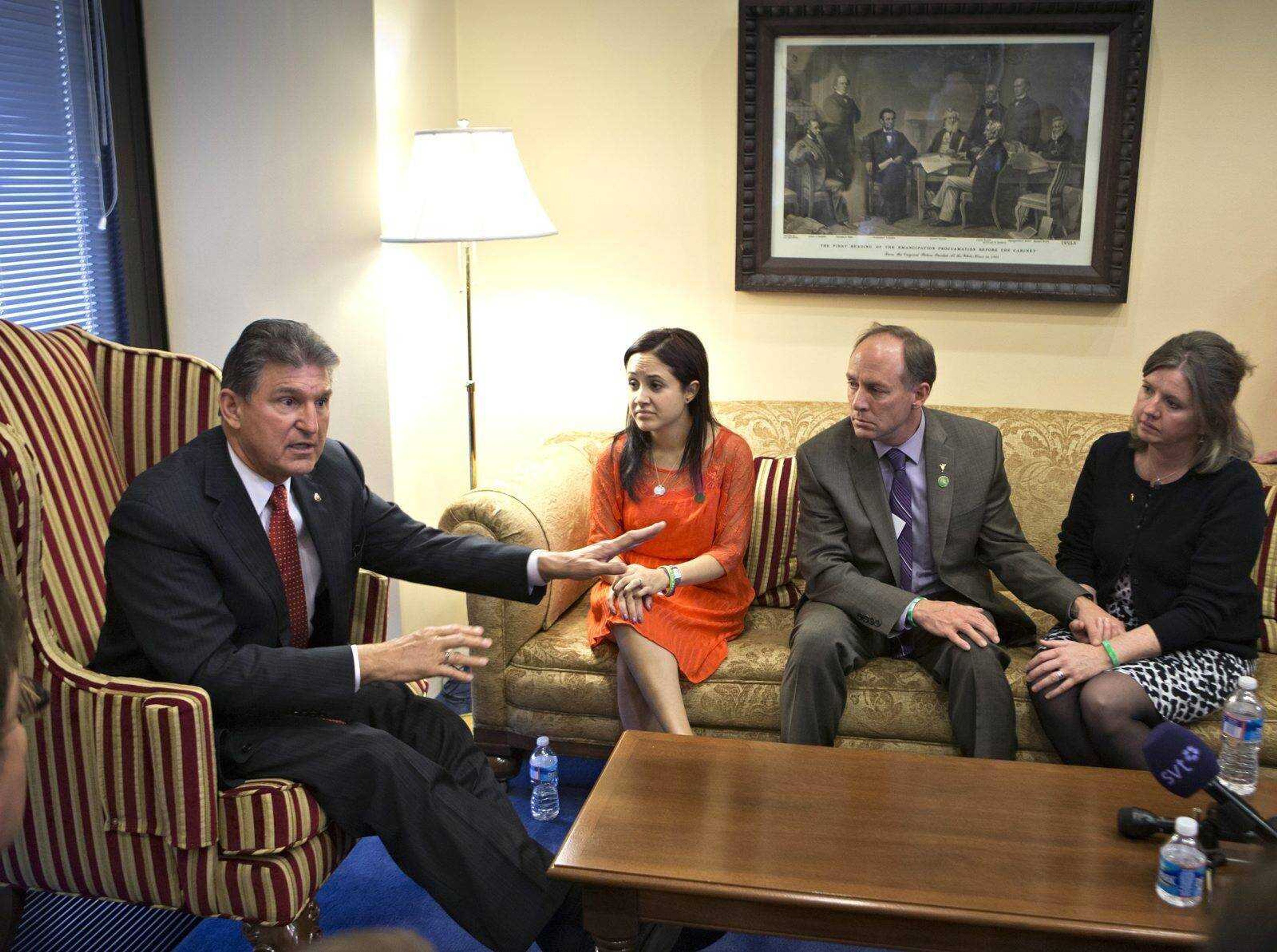 Sen. Joe Manchin, D-W.Va., left, meets in his office with families of victims of the Sandy Hook Elementary School shooting in Newtown, Conn., on the day he announced he reached a bipartisan deal on expanding background checks to more gun buyers Wednesday on Capitol Hill in Washington. From left are Manchin, Nelba Marquez-Greene, mother of victim Ana Marquez-Greene, and Mark and Jackie Barden, parents of victim Daniel Barden. (J. Scott Applewhite ~ Associated Press)