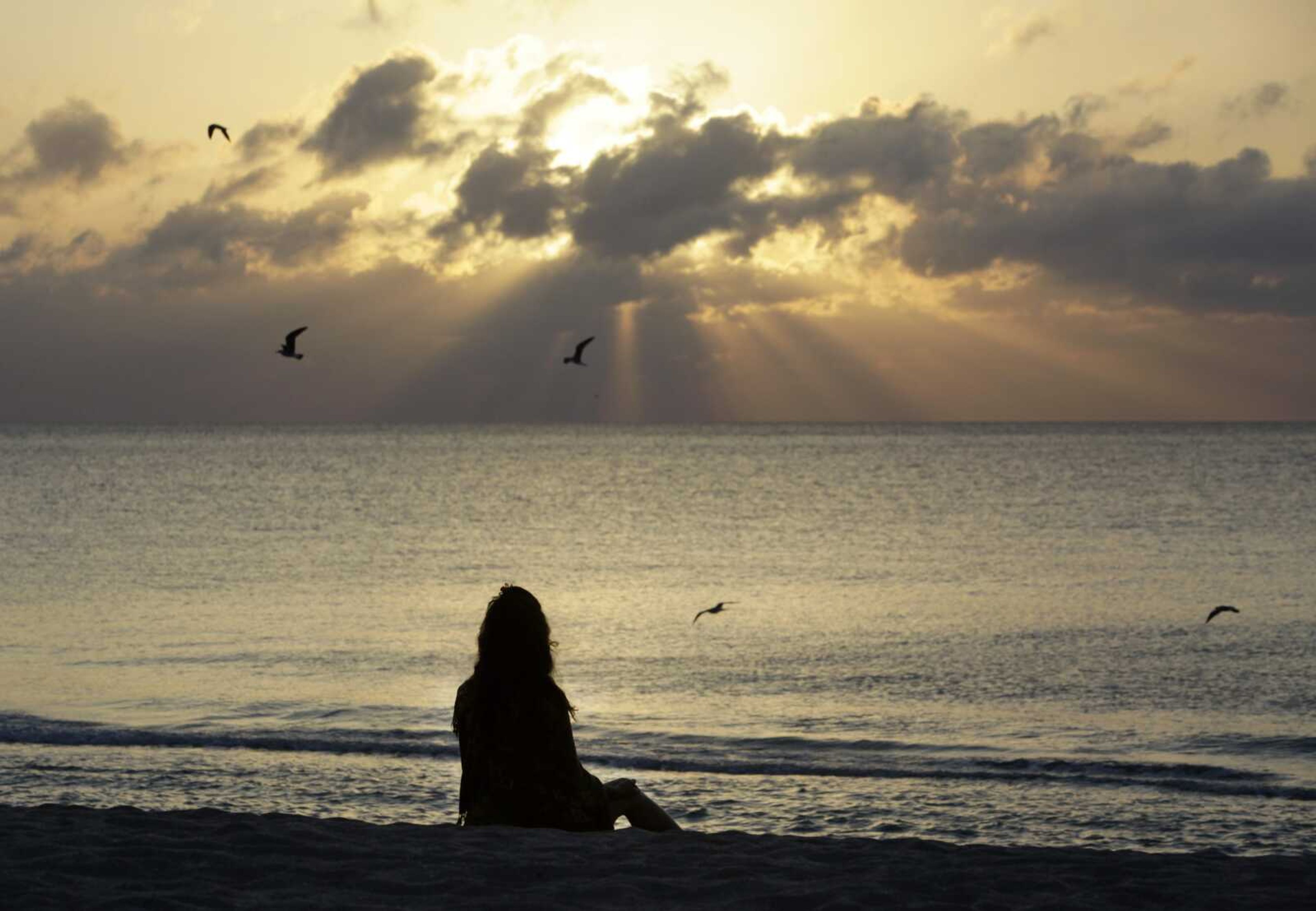 A woman meditates on the beach April 28, 2010, in Miami Beach, Florida. According to a study published Wednesday, Nov. 9, in the journal JAMA Psychiatry, mindfulness meditation worked as well as a standard drug for treating anxiety in the first head-to-head comparison.