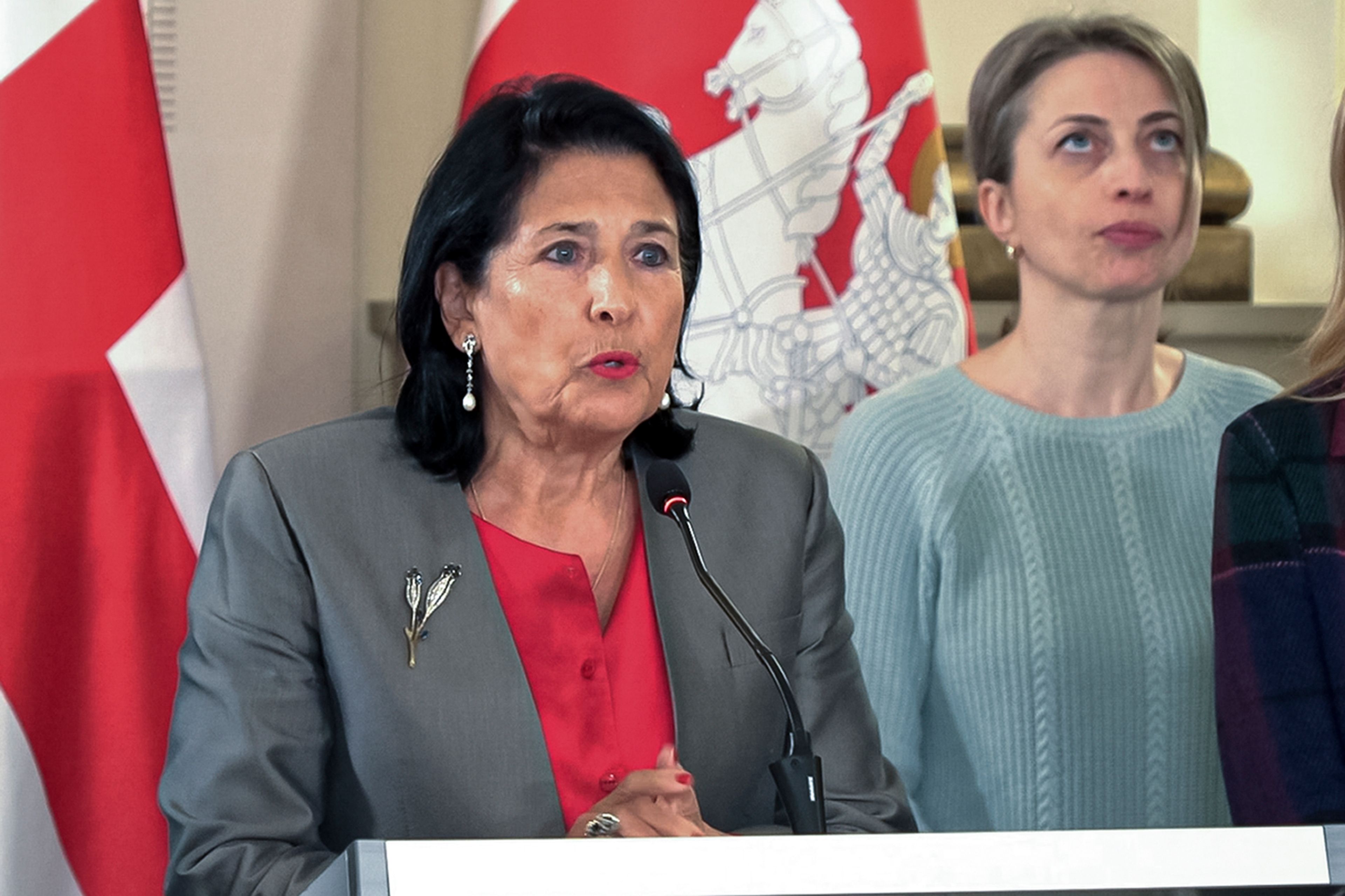 In this photo taken from video, Georgian President Salome Zourabichvili, left, speaks to the media as speaks to the media as and Nana Malashkhia, who leads the Coalition for Change parliament list, right, stands near, after the parliamentary election in Tbilisi, Georgia, on Sunday, Oct. 27, 2024. (AP Photo/Kostya Manenkov)