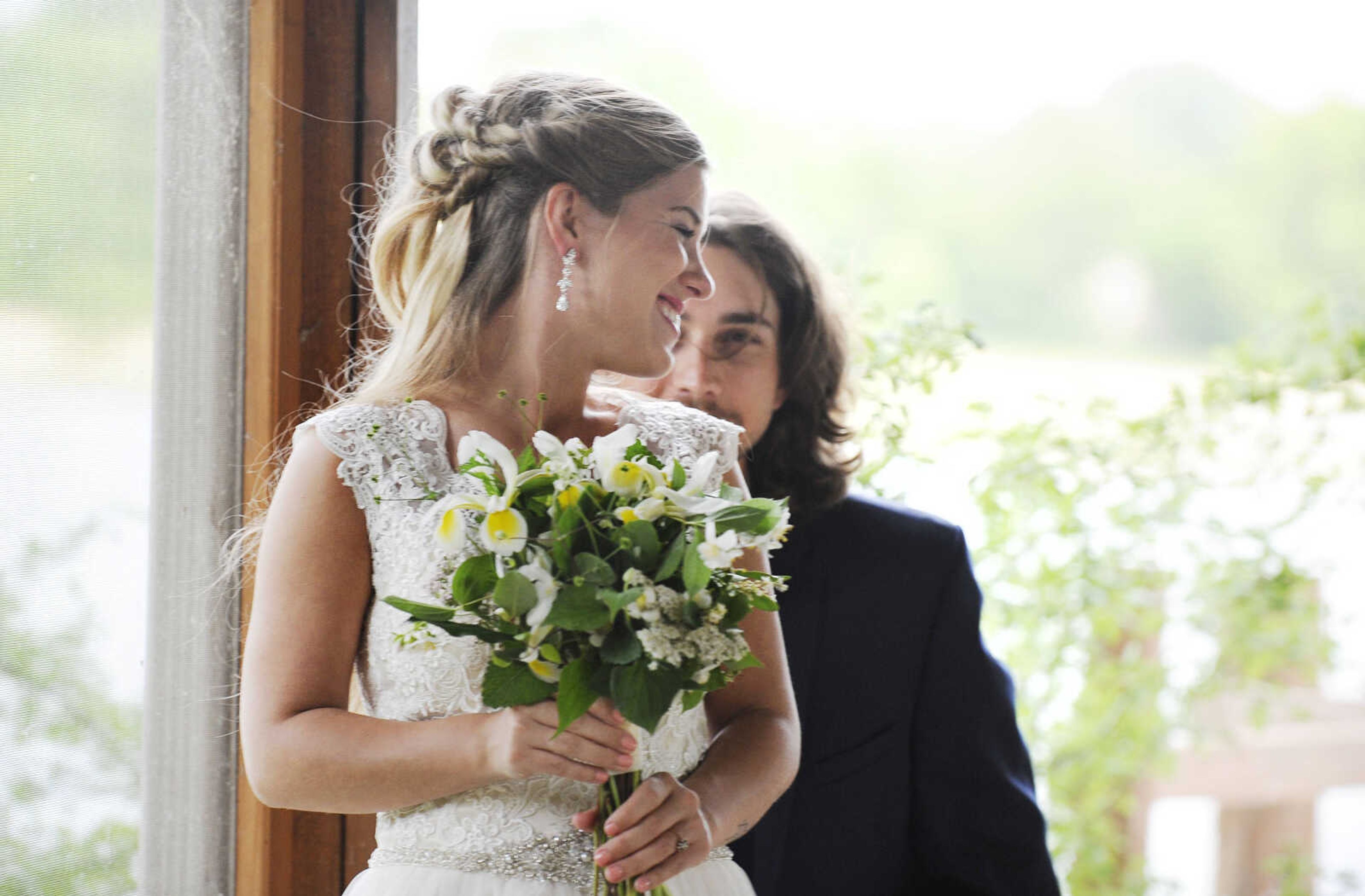 On Lydia: Allure Bridals gown in ivory with tulle skirt, lace bodice, beaded waste and button-back closure. Drop earrings by Jim Ball. All available at Joy's Bridal in Sikeston, Missouri. 

On Evan: Navy Sterling slim fit wedding suit by Michael Kors with navy plaid bow tie. Provided by Jim's Formal Wear and available at Garber's Men's Wear in Cape Girardeau.


On Evan: Navy Sterling slim fit wedding suit by Michael Kors with navy plaid bow tie. Provided by Jim's Formal Wear and available at Garber's Men's Wear in Cape Girardeau.