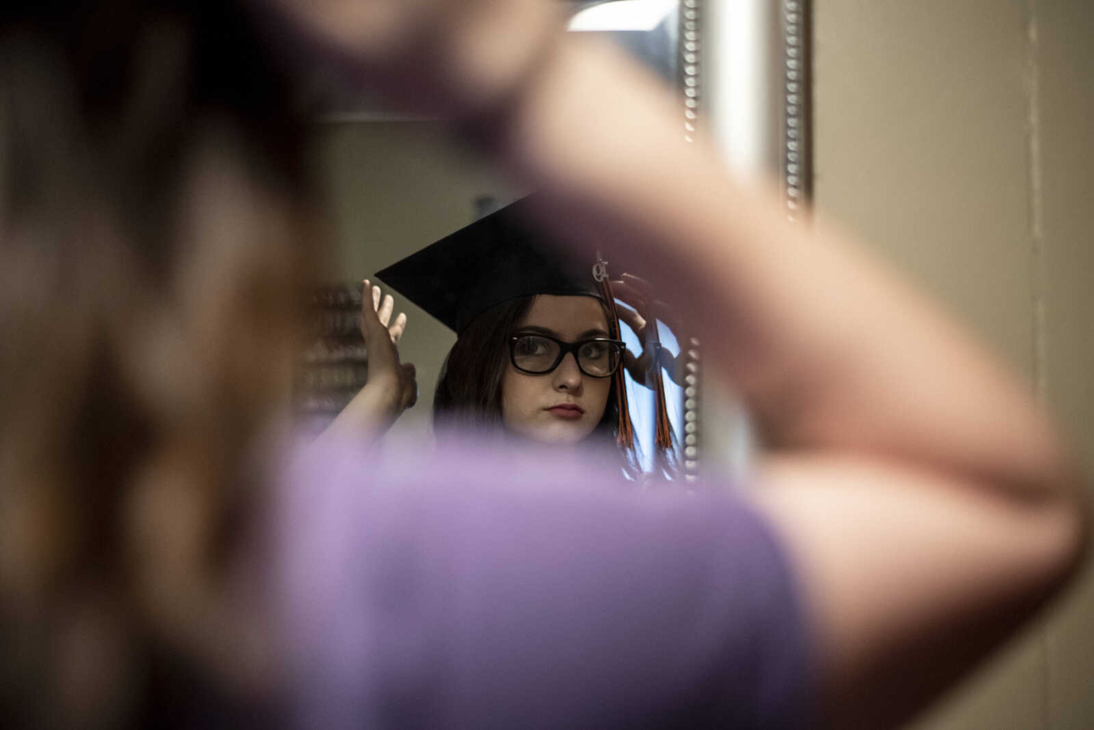 Emily Medlock tries on her graduation cap with her finished hair and makeup the morning of graduation Sunday, May 12, 2019, at home in Cape Girardeau.