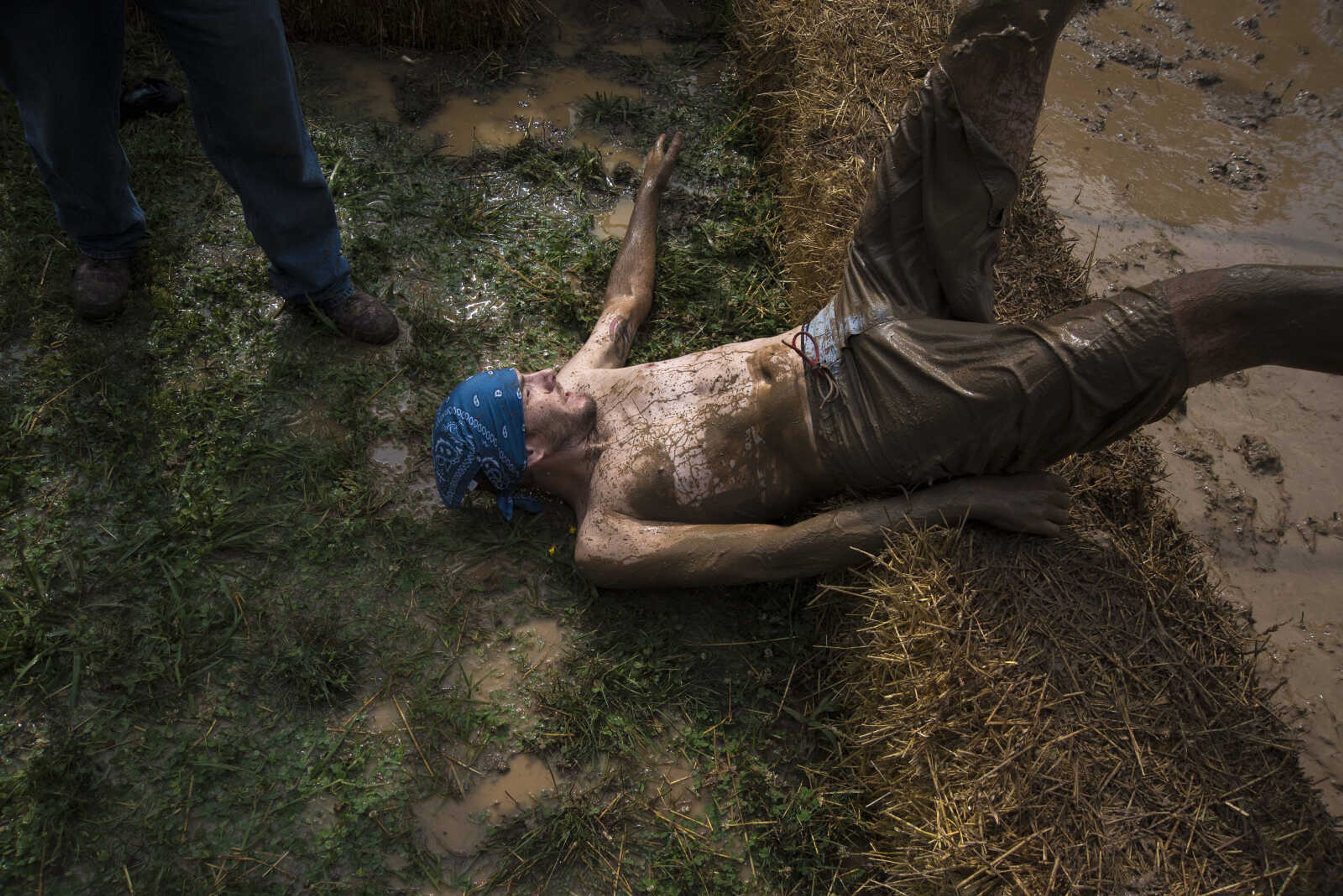 Chris Carr falls out of the mug pit during mud volleyball for the Jackson Parks and Recreation's July 4th celebration Tuesday, July 4, 2017 in Jackson City Park.