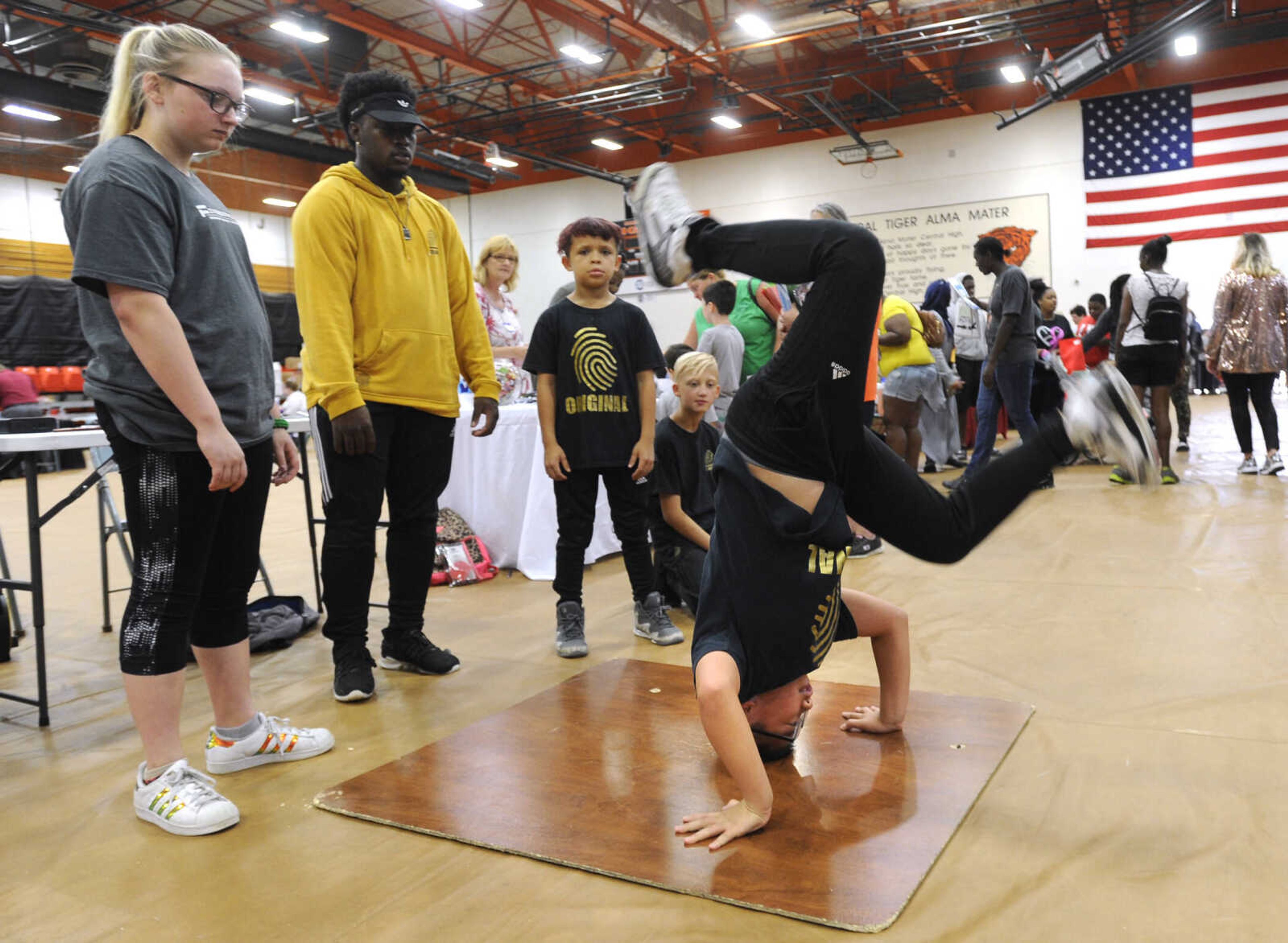 FRED LYNCH ~ flynch@semissourian.com
Yan Zhang demonstrates B-boy dance moves at the Fingerprint Urban Dance Studio booth Wednesday, Aug. 1, 2018 during the Back to School Kickoff at Central Junior High School Tiger Field House.