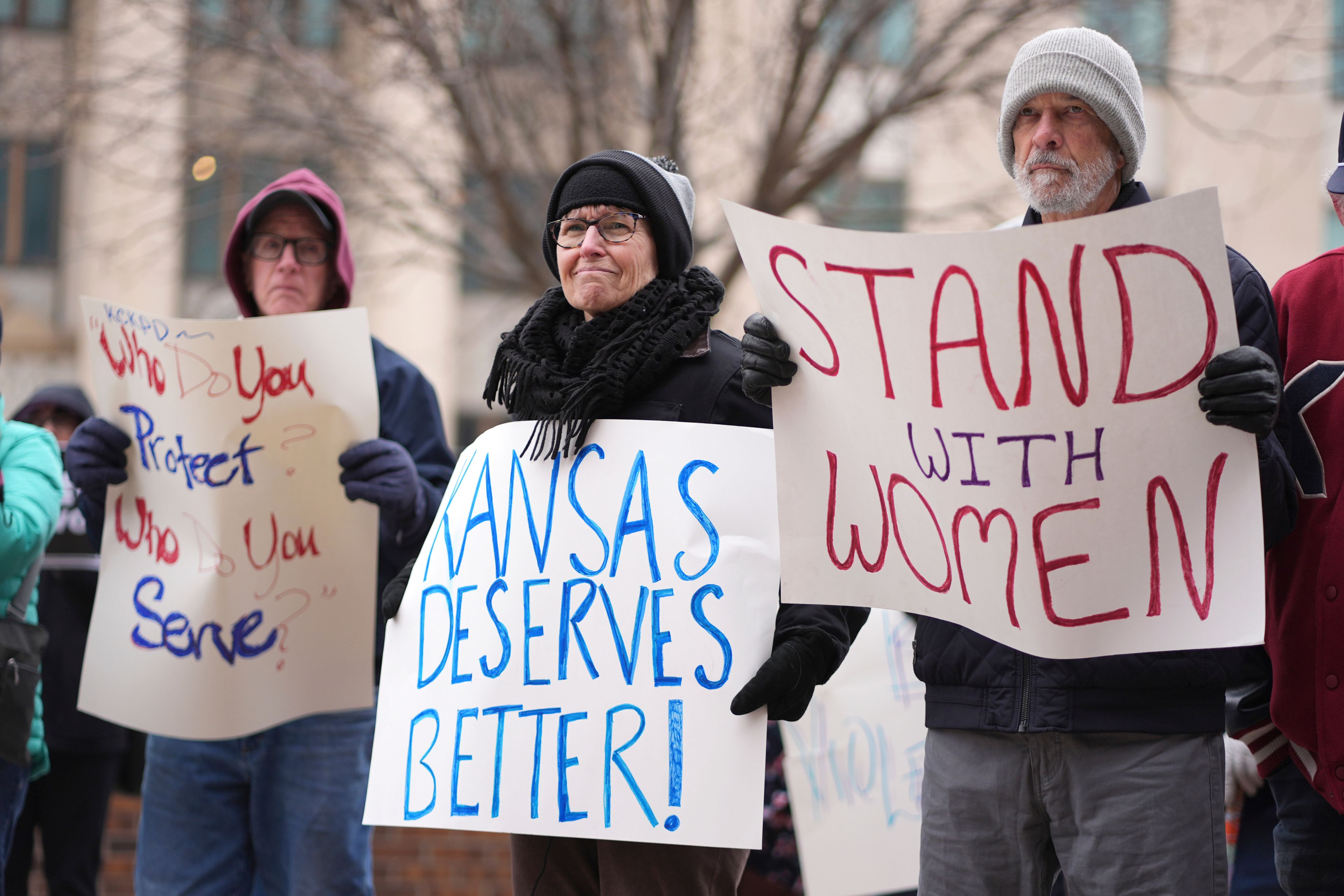 People listen to a speaker at a rally outside the federal courthouse on was was to be the opening day for a trial for former police detective Roger Golubski, Monday, Dec. 2, 2024, in Topeka, Kan. (AP Photo/Charlie Riedel)