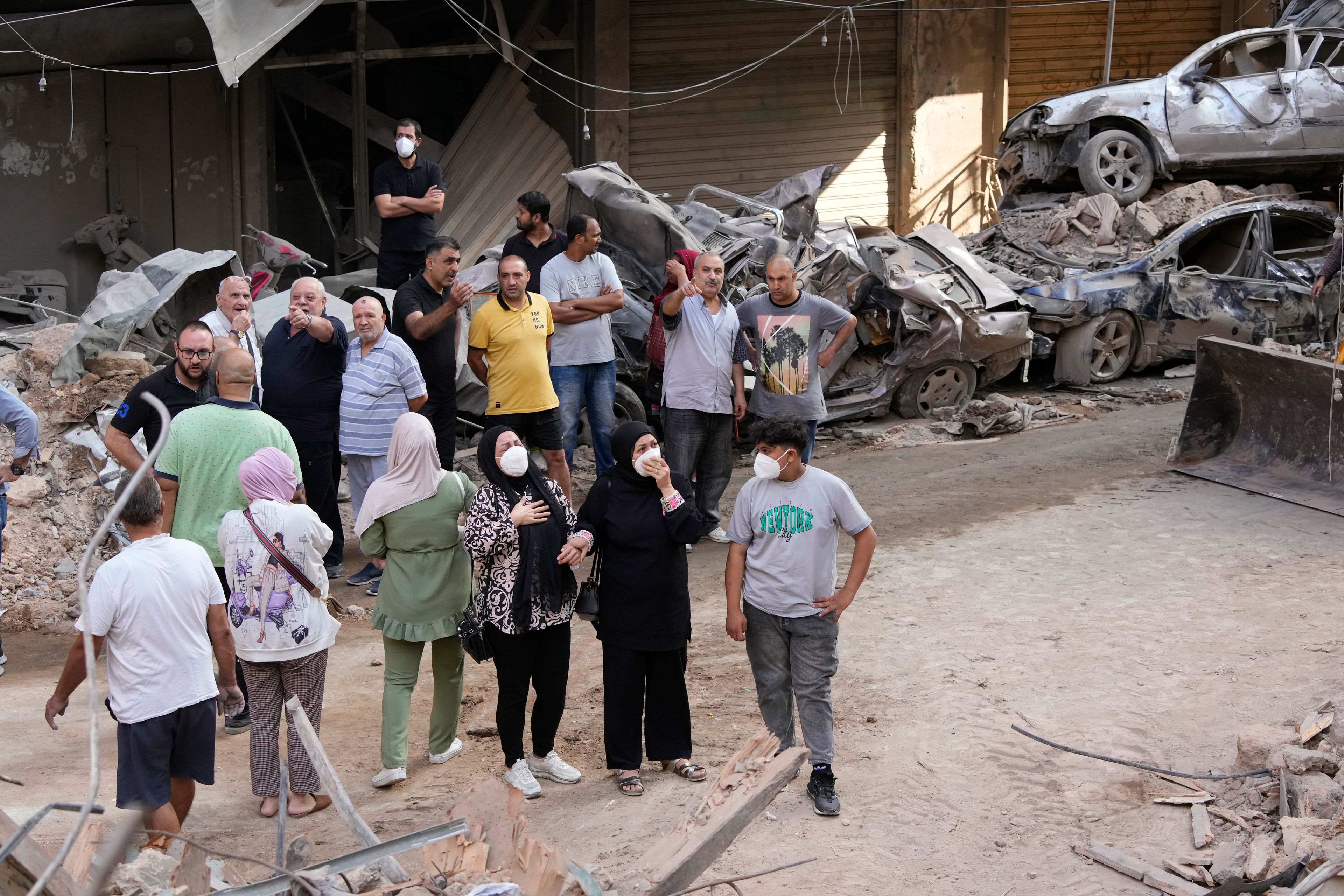 Residents react in front of their destroyed apartment at the site of Thursday's Israeli airstrike in Beirut, Lebanon, Friday, Oct. 11, 2024. (AP Photo/Hassan Ammar)